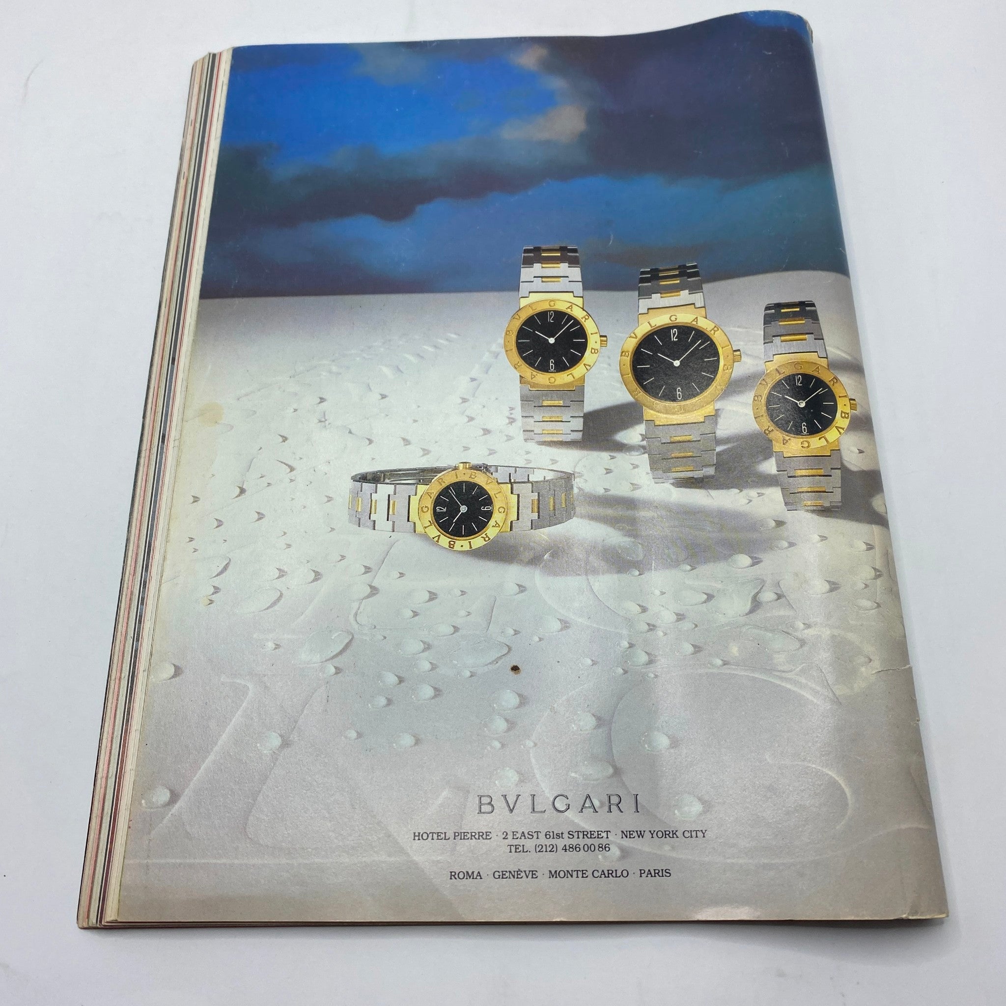 Back advertisement page of VTG The Movies Magazine July 1983 featuring Bvlgari watches, depicting stylish timepieces against a scenic background.