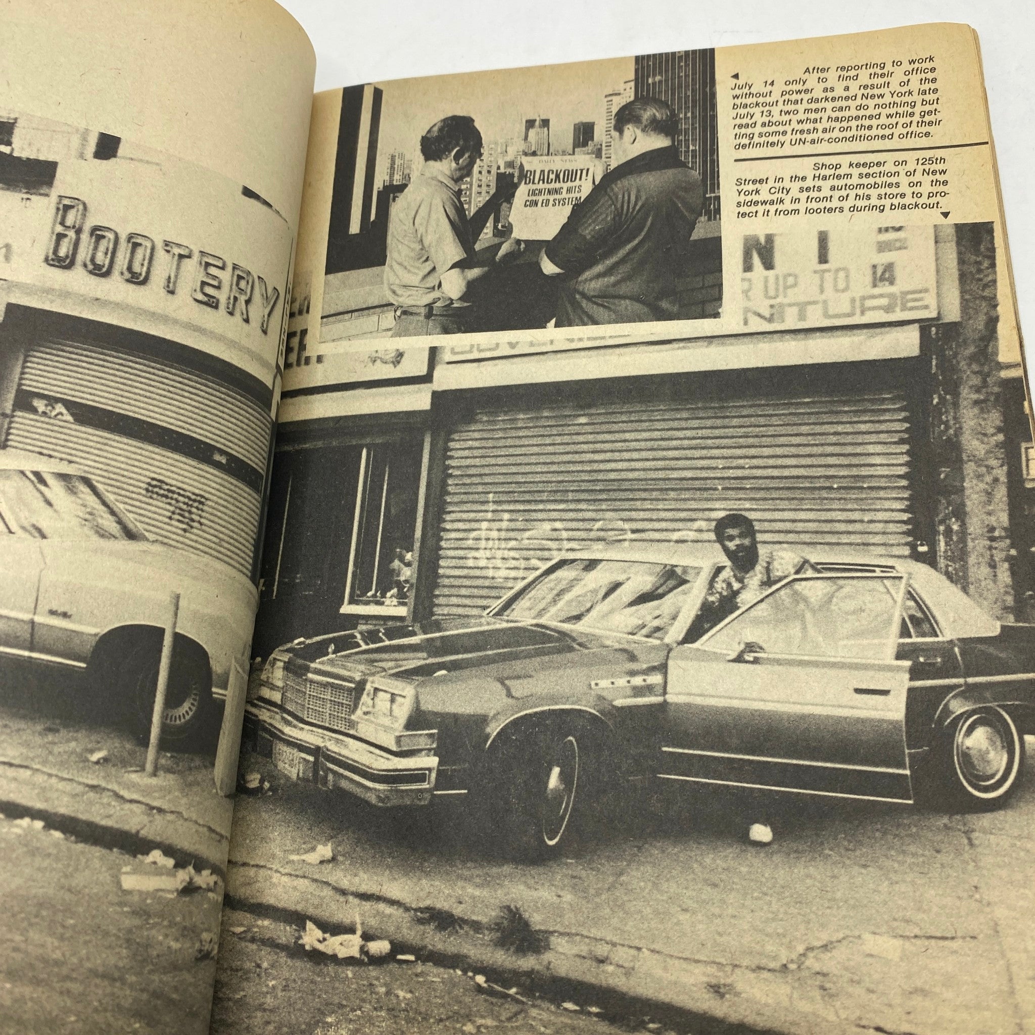 Image from the VTG Blackout '77 Magazine A Night To Remember U.S. Collector's Edition, showcasing a shopkeeper discussing the blackout during 1977 highlighted with urban scenes.