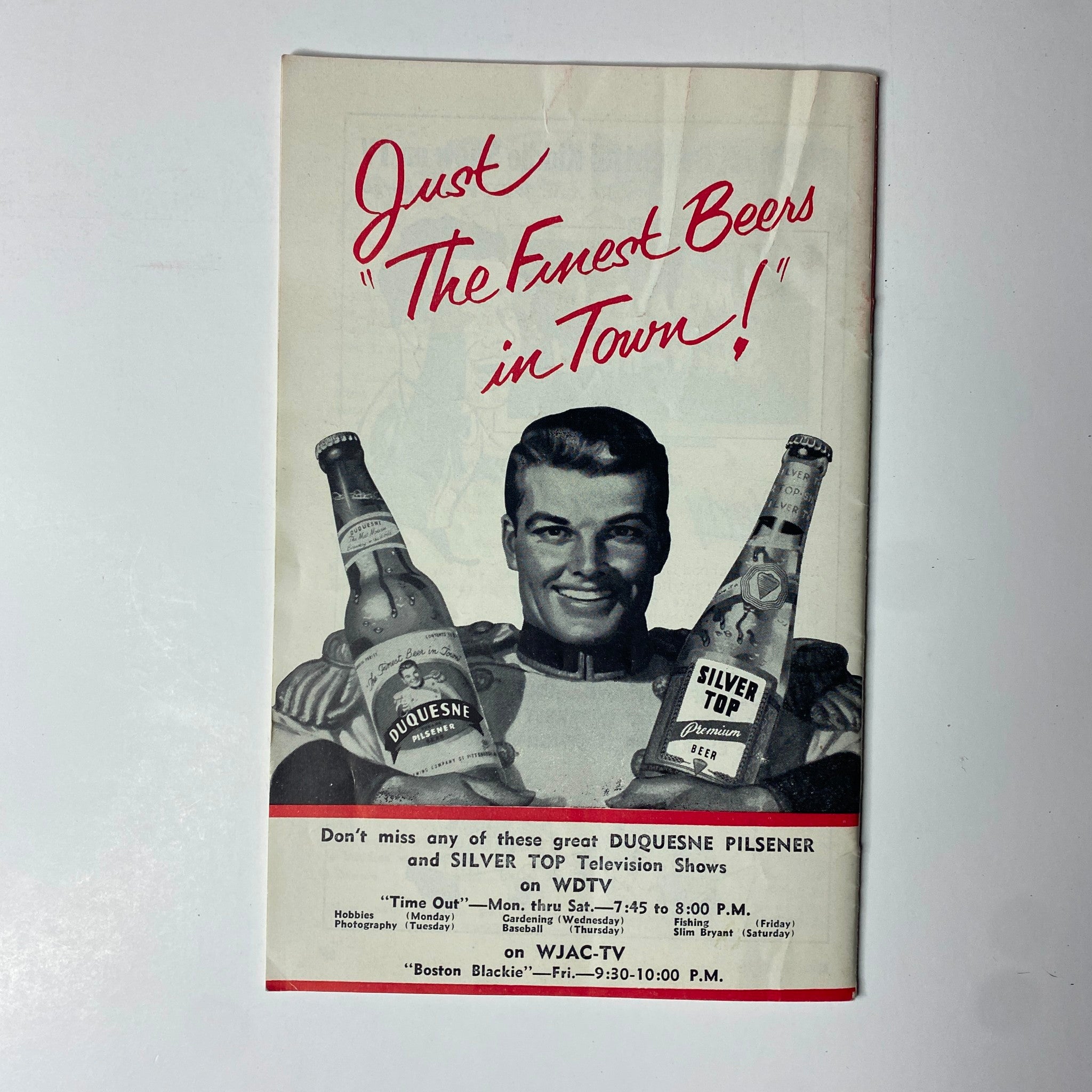 Advertisement page from TV Digest Magazine March 28, 1953 promoting 'Duquesne Pilsener' and 'Silver Top' beers. Features a smiling male model holding two bottles, showcasing local TV programming on WJAC-TV.