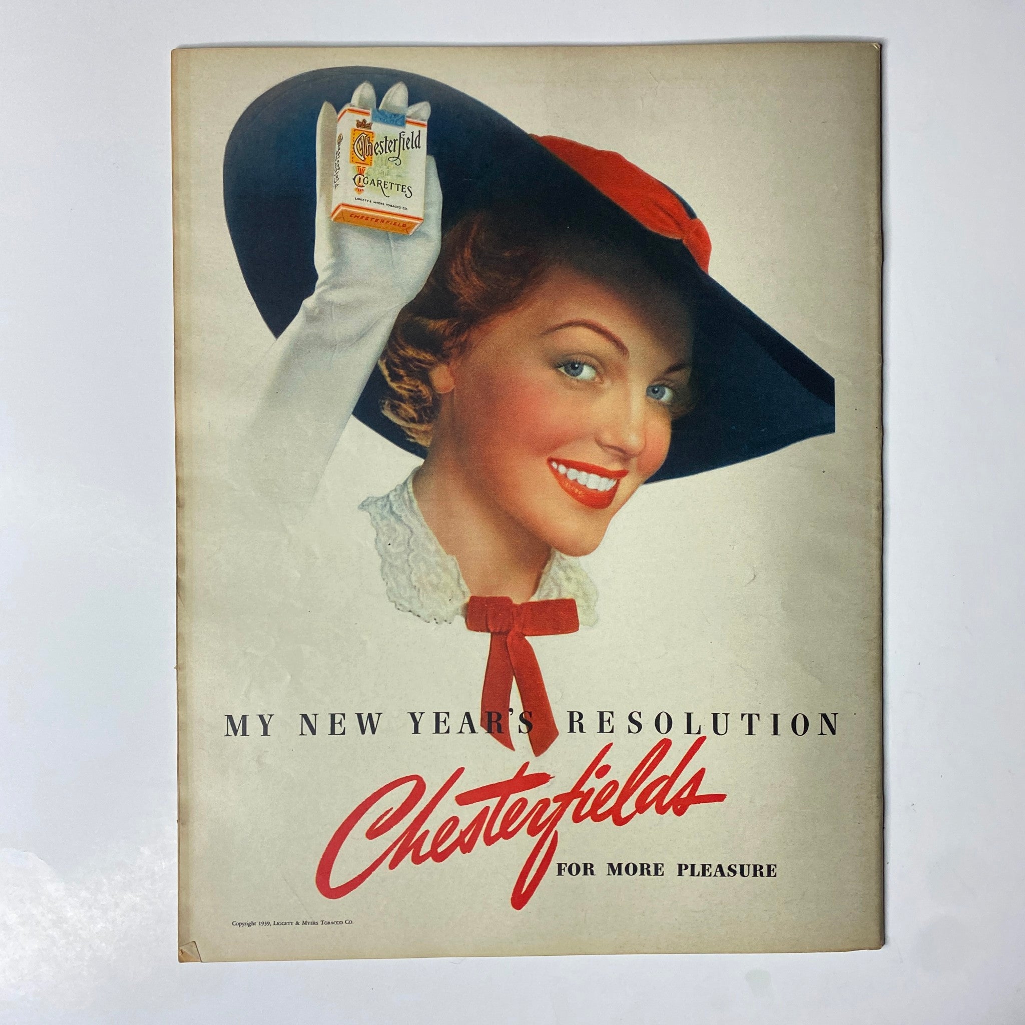 Look Magazine January 17, 1939 advertisement for Chesterfield cigarettes, featuring a smiling woman promoting the product in a classic vintage style.