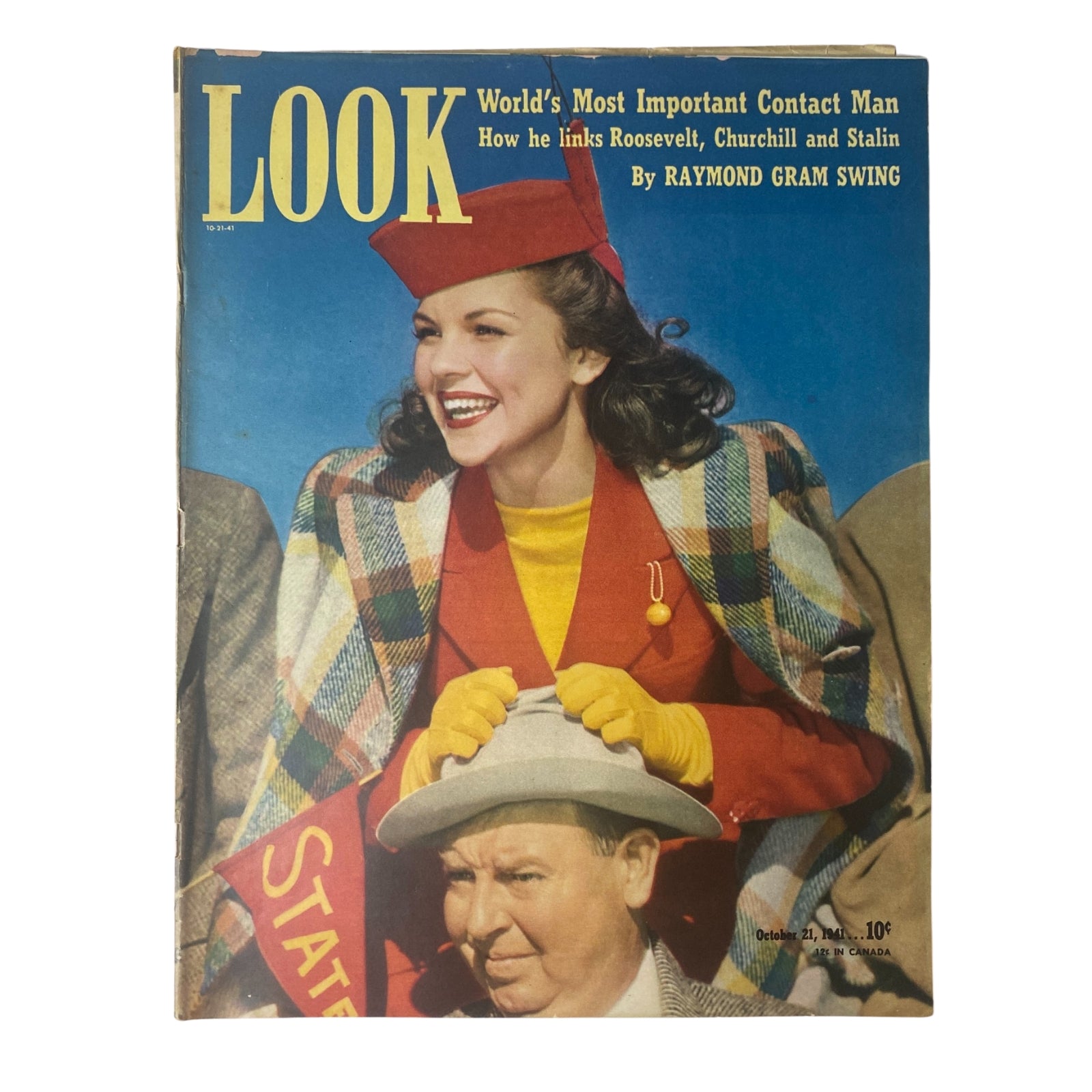 Look Magazine cover from October 21, 1941, featuring a spirited photograph of a woman in vibrant clothing and a red hat joyfully smiling, representing the article 'World's Most Important Contact Man' by Raymond Gram Swing.