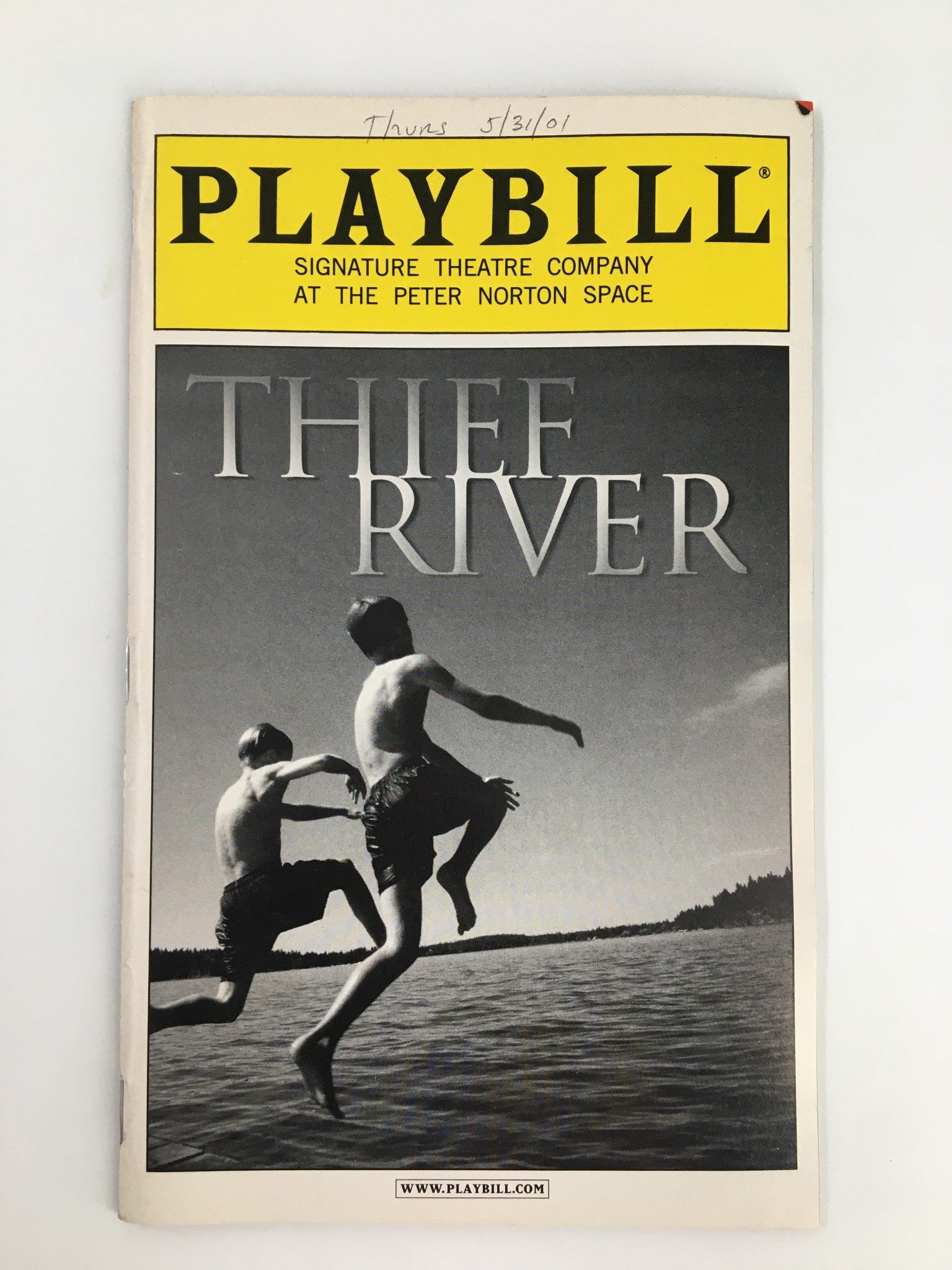 2001 Playbill for Thief River, produced by Signature Theatre Company, featuring a striking black and white cover image of two boys jumping into water, with promotional text and details about the show.