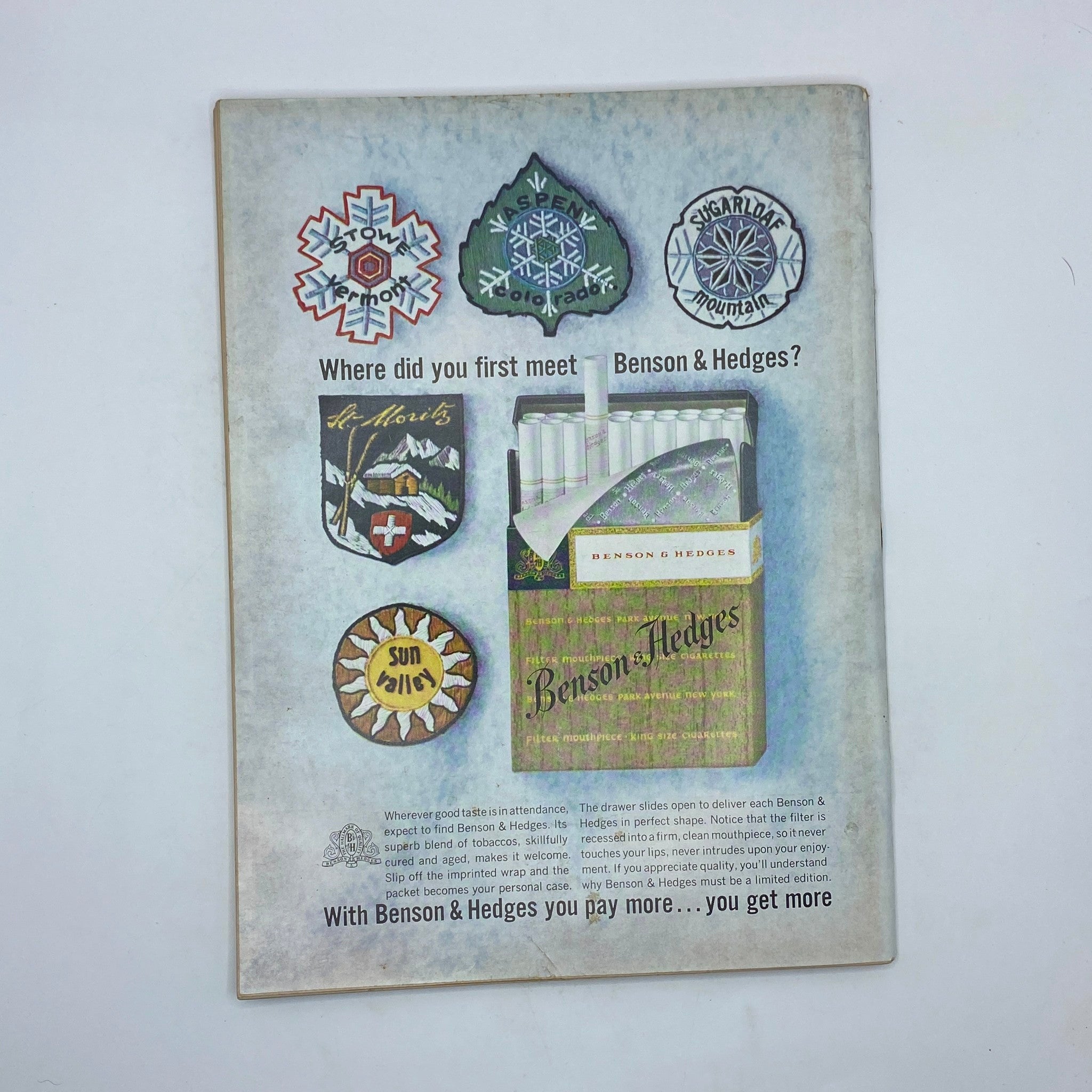 Back cover of The New Yorker, March 21, 1964 issue, showcasing an advertisement for Benson & Hedges cigarettes, with imagery including badges of ski resorts and a pack of cigarettes.
