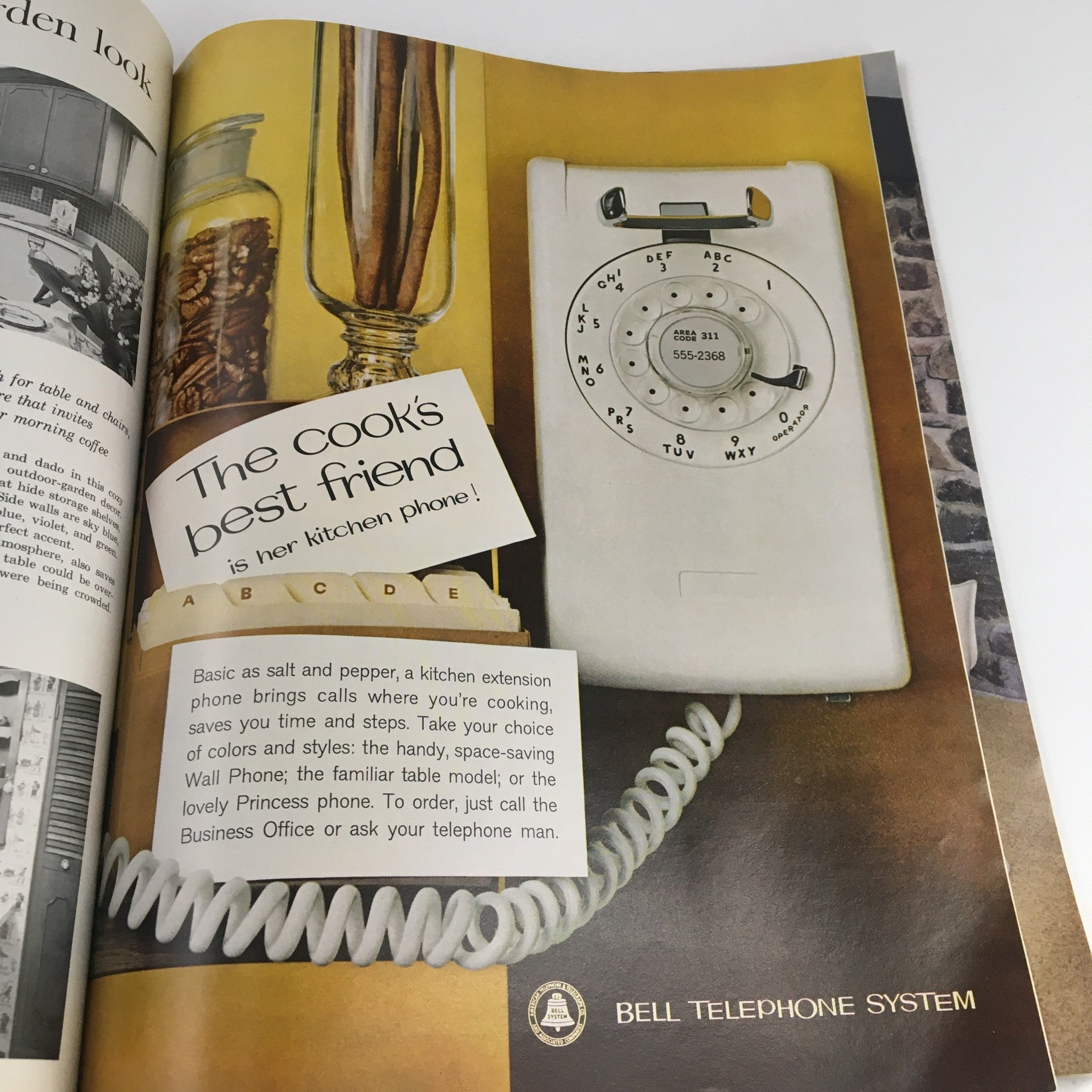 Better Homes & Gardens Magazine Kitchen Ideas 1963 - A vintage kitchen telephone advertisement emphasizing the importance of a kitchen phone in modern cooking and household management.