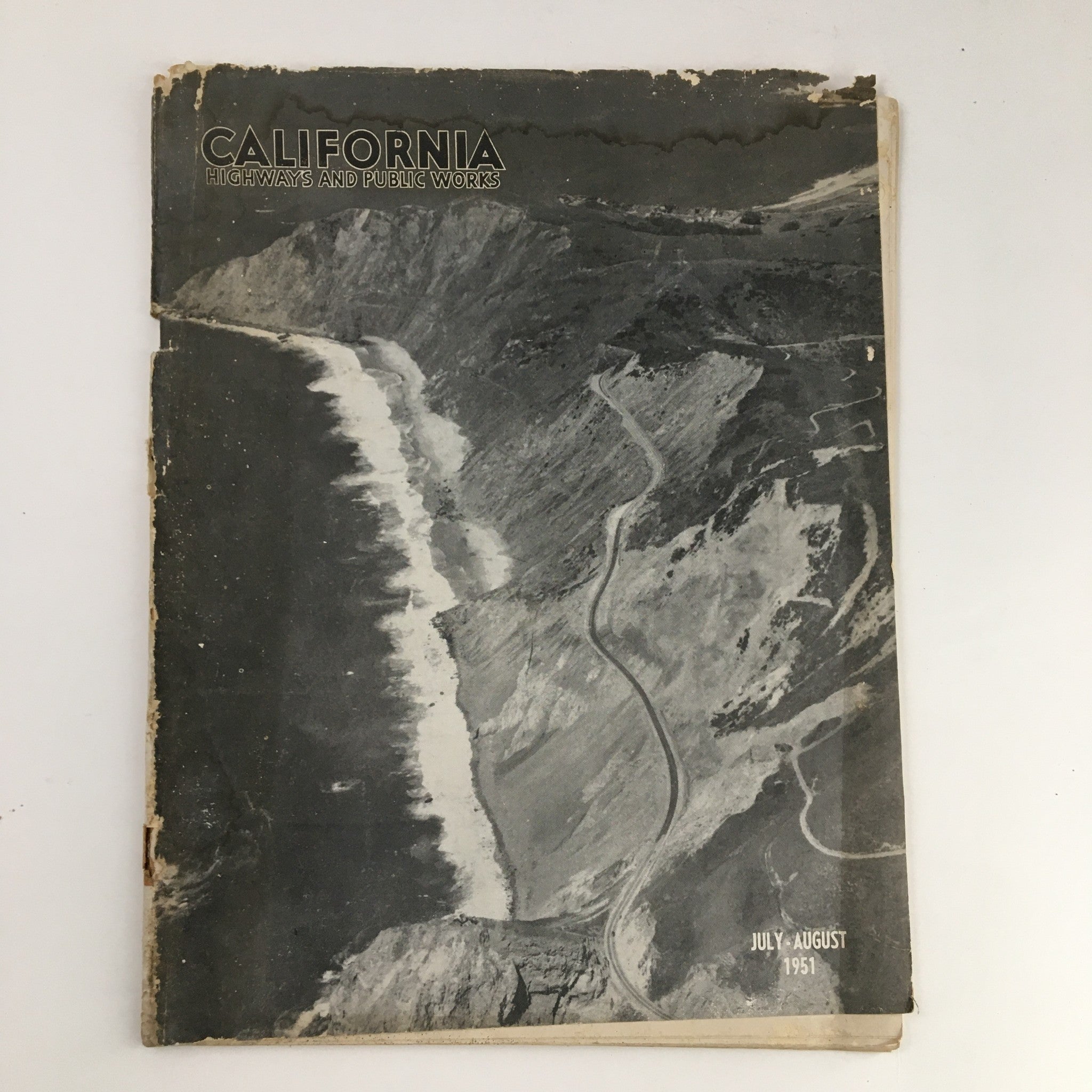 Cover of the California Highways and Public Works July 1951 magazine featuring Route 1 on Pedro Mountain, showcasing mid-20th century California infrastructure.