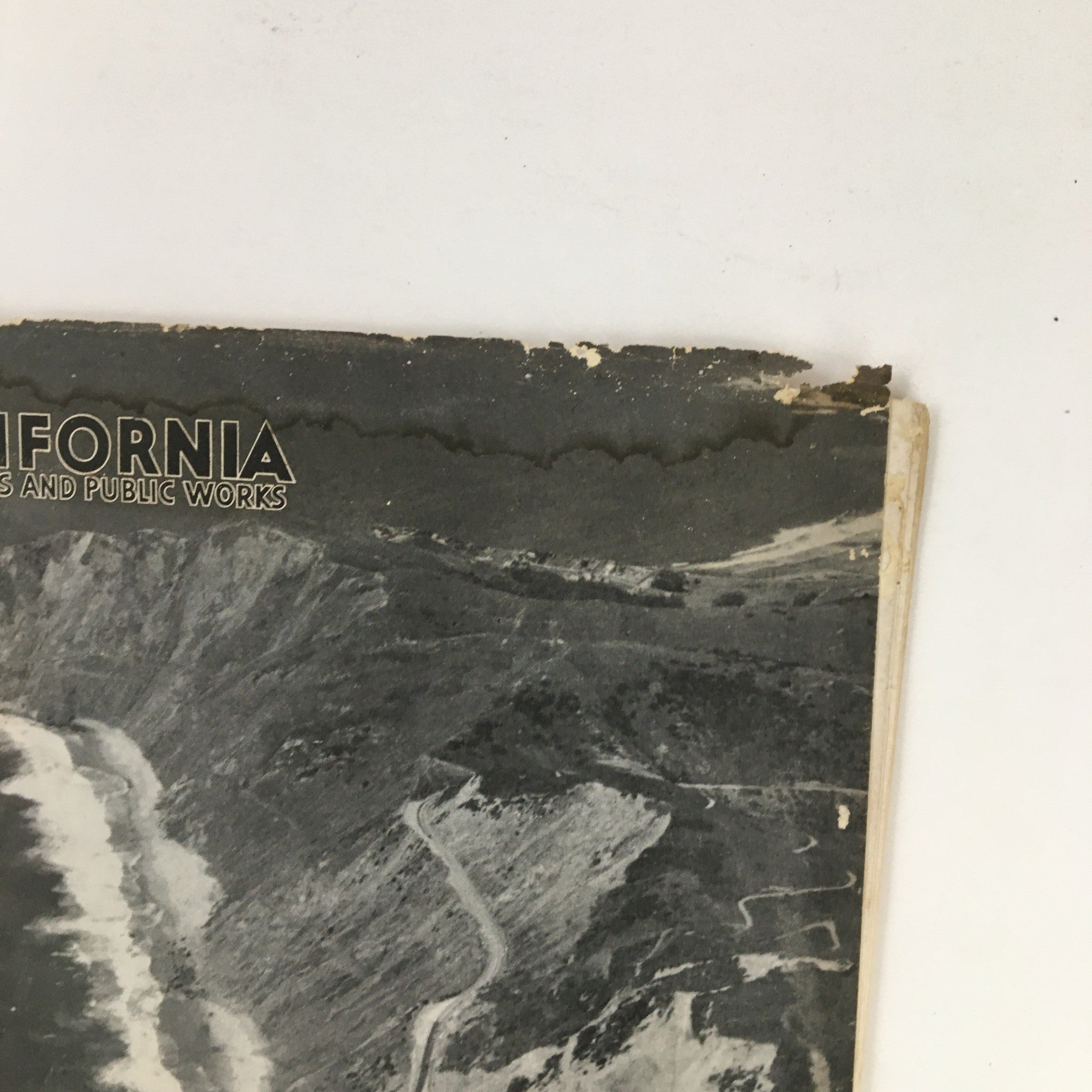 Close-up of the cover of the California Highways and Public Works July 1951 magazine highlighting the iconic Route 1 on Pedro Mountain.