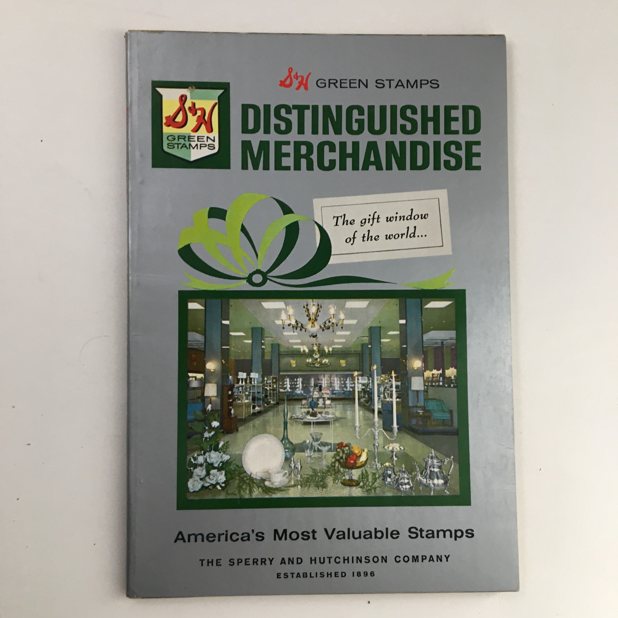 S&H Green Stamps Distinguished Merchandise 1963 cover showcasing 'America's Most Valuable Stamps' with a decorative theme and images of various products including plates and glassware.