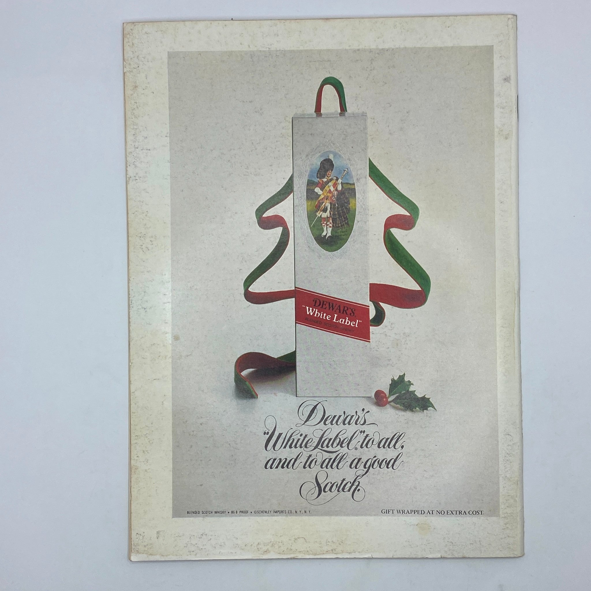 Vintage advertisement from The New Yorker Magazine December 25, 1978, featuring a decorative design with Dewar's White Label Scotch whiskey, showcasing the holiday spirit with ribbons and a festive message.