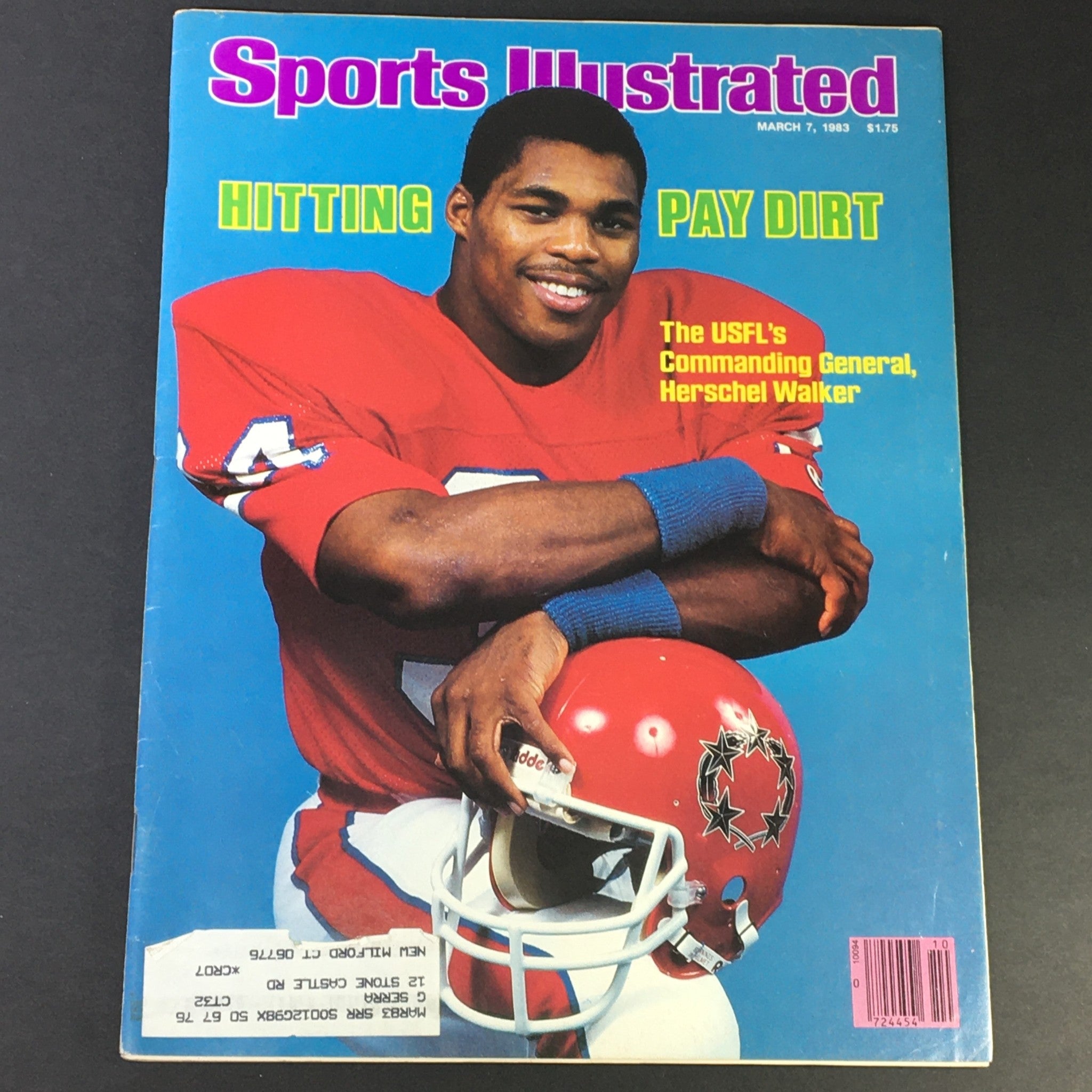 Vintage Sports Illustrated magazine cover from March 7, 1983, featuring USFL's General Herschel Walker, capturing him in a football uniform, smiling, with a helmet in hand.