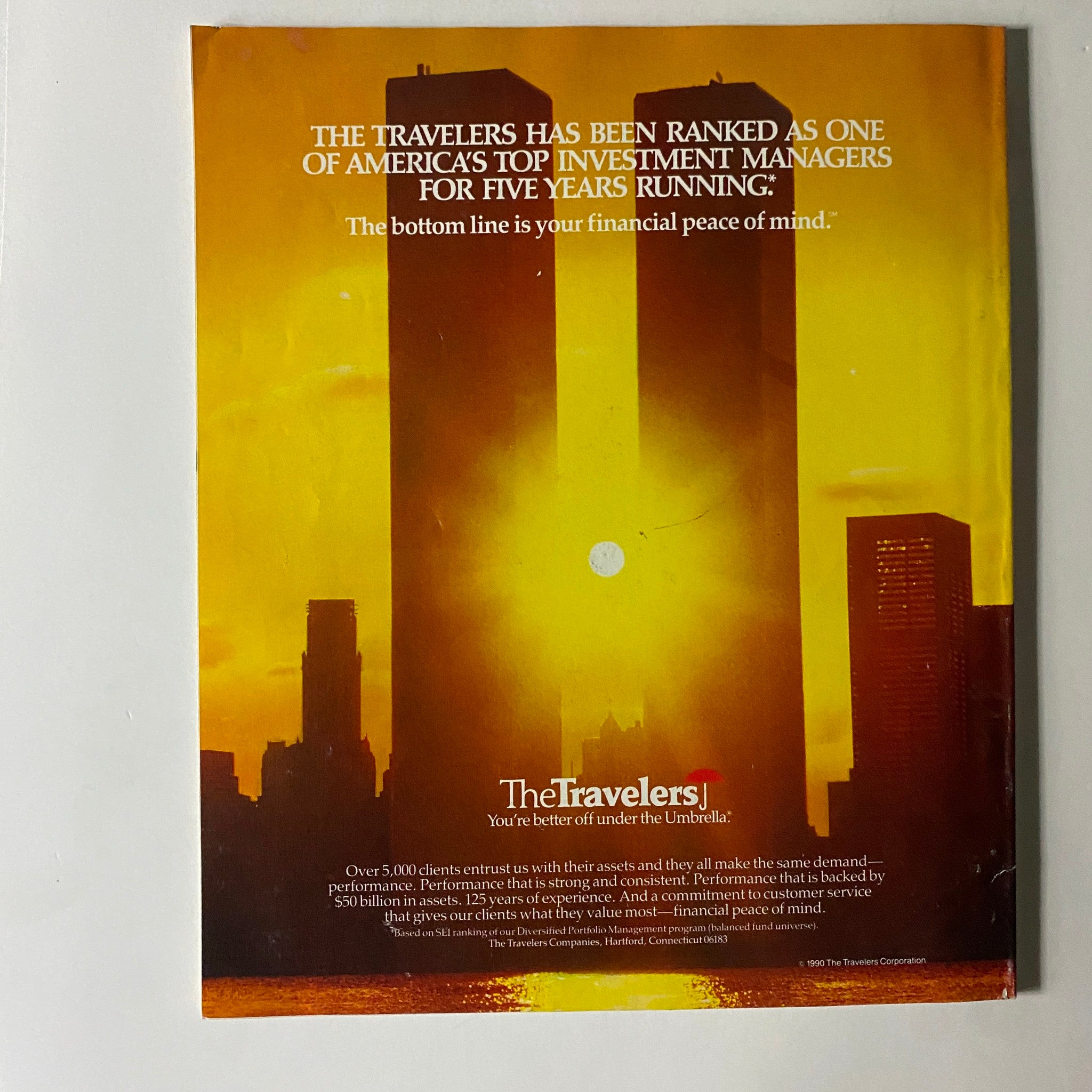 Back cover of Fortune Magazine July 16, 1990, featuring an advertisement for The Travelers, highlighting their ranking as a top investment manager with a sunset backdrop.