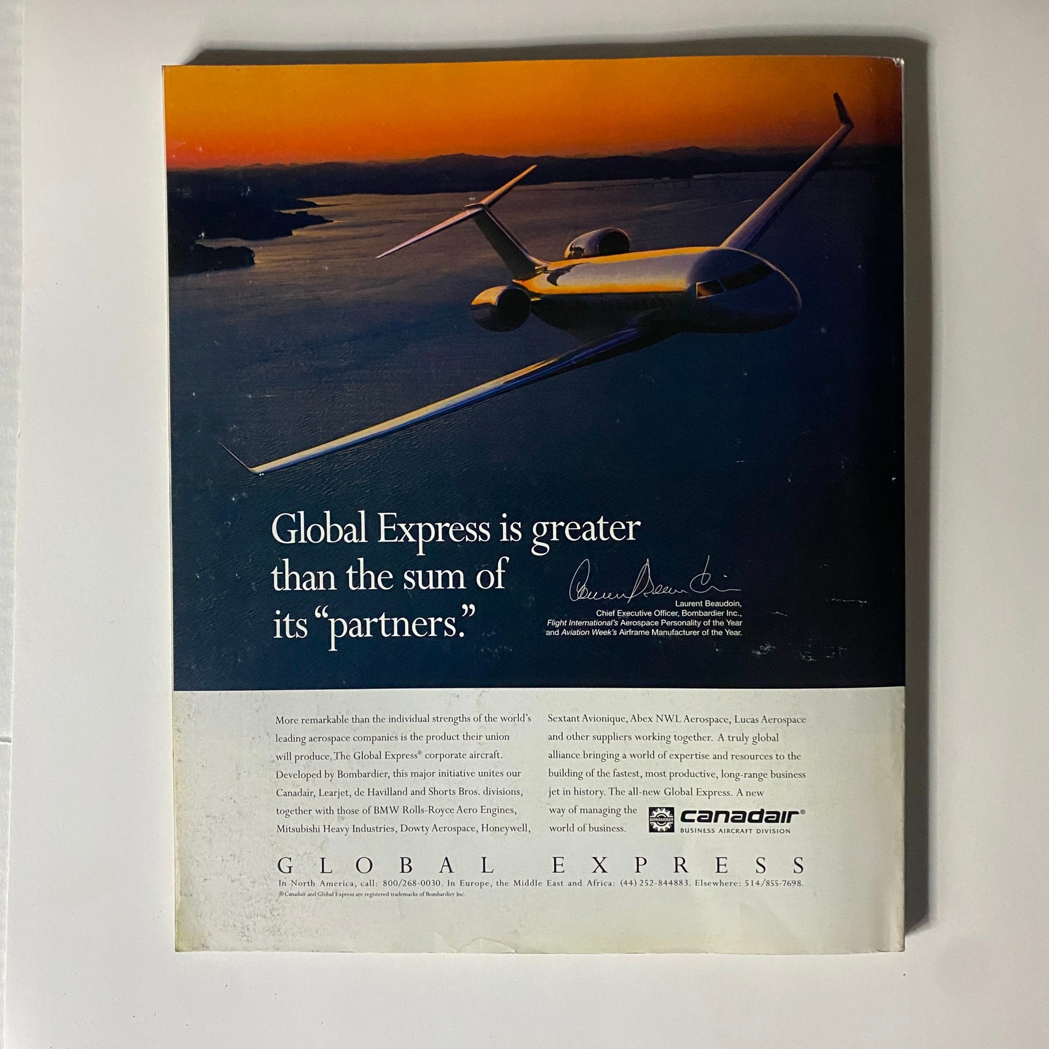 Advertisement for Global Express featuring an aircraft flying over a serene landscape, highlighting the tagline 'Global Express is greater than the sum of its partners.' from Fortune Magazine, October 17, 1994 issue with CEO Jack Smith and Peter Senge.