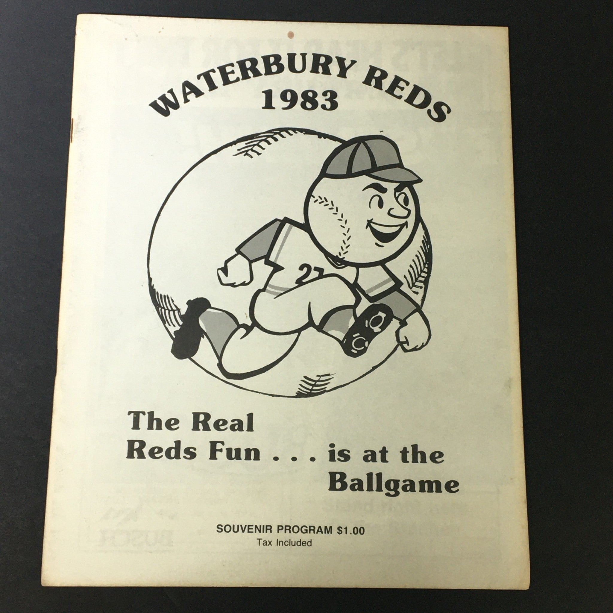 Cover page of the Vintage MLB Waterbury Reds 1983 Official Souvenir Program featuring a cartoon mascot of a baseball player and the program title.