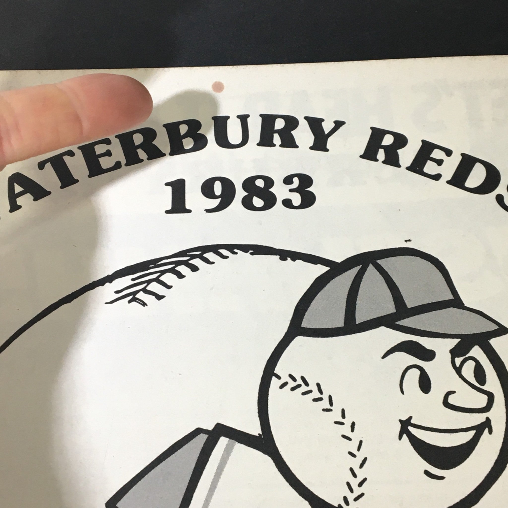 Close-up of the cover of the Vintage MLB Waterbury Reds 1983 Official Souvenir Program, showcasing the mascot and title with minor wear visible.