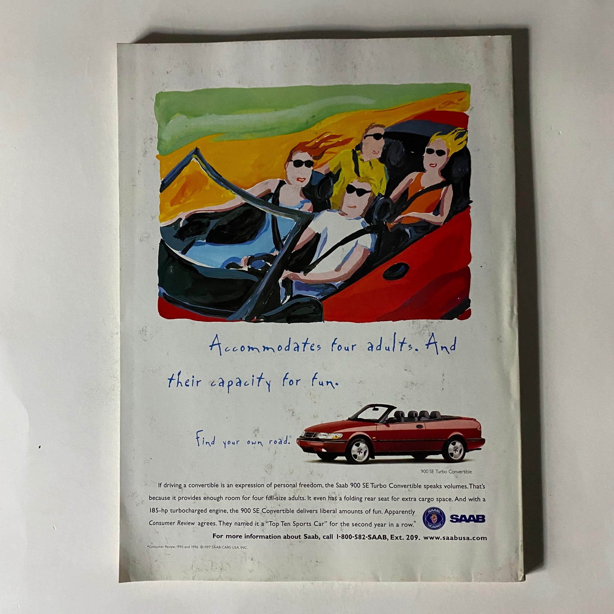 Back cover advertisement from Fortune Magazine April 14, 1997 showcasing the Saab 900 SE Turbo Convertible with an artistic illustration and tagline about accommodating four adults and their capacity for fun.