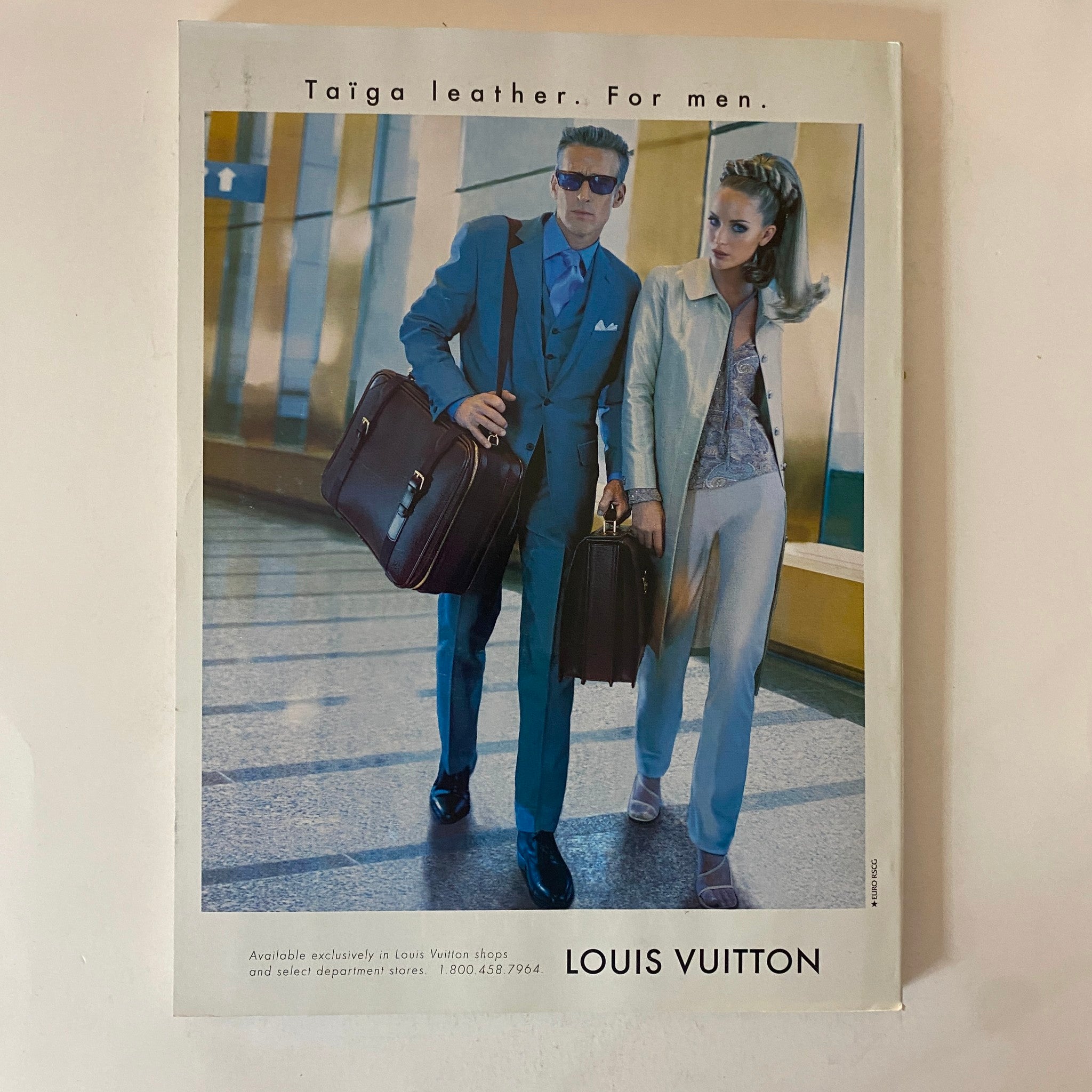 Louis Vuitton advertisement featuring a stylish man and woman modeling Taiga leather products, featured in Fortune Magazine October 27, 1997.