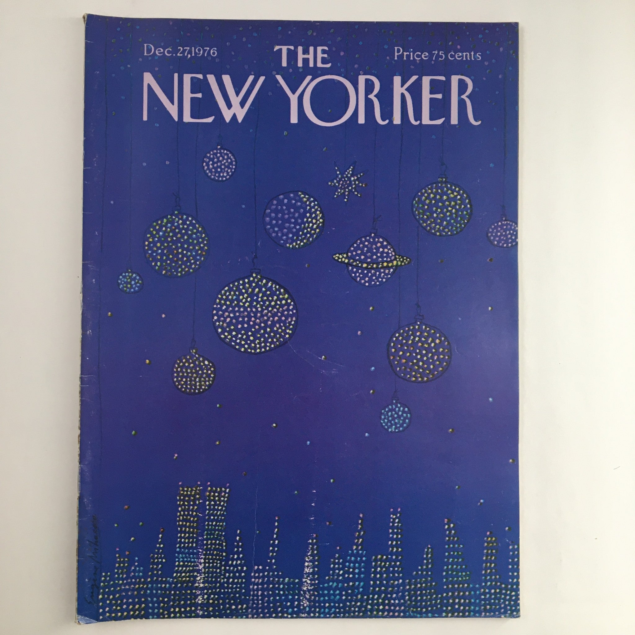 Cover of The New Yorker Magazine December 27 1976, featuring a blue background with colorful decorative ornaments and stars, designed by Eugene Mihaesco.
