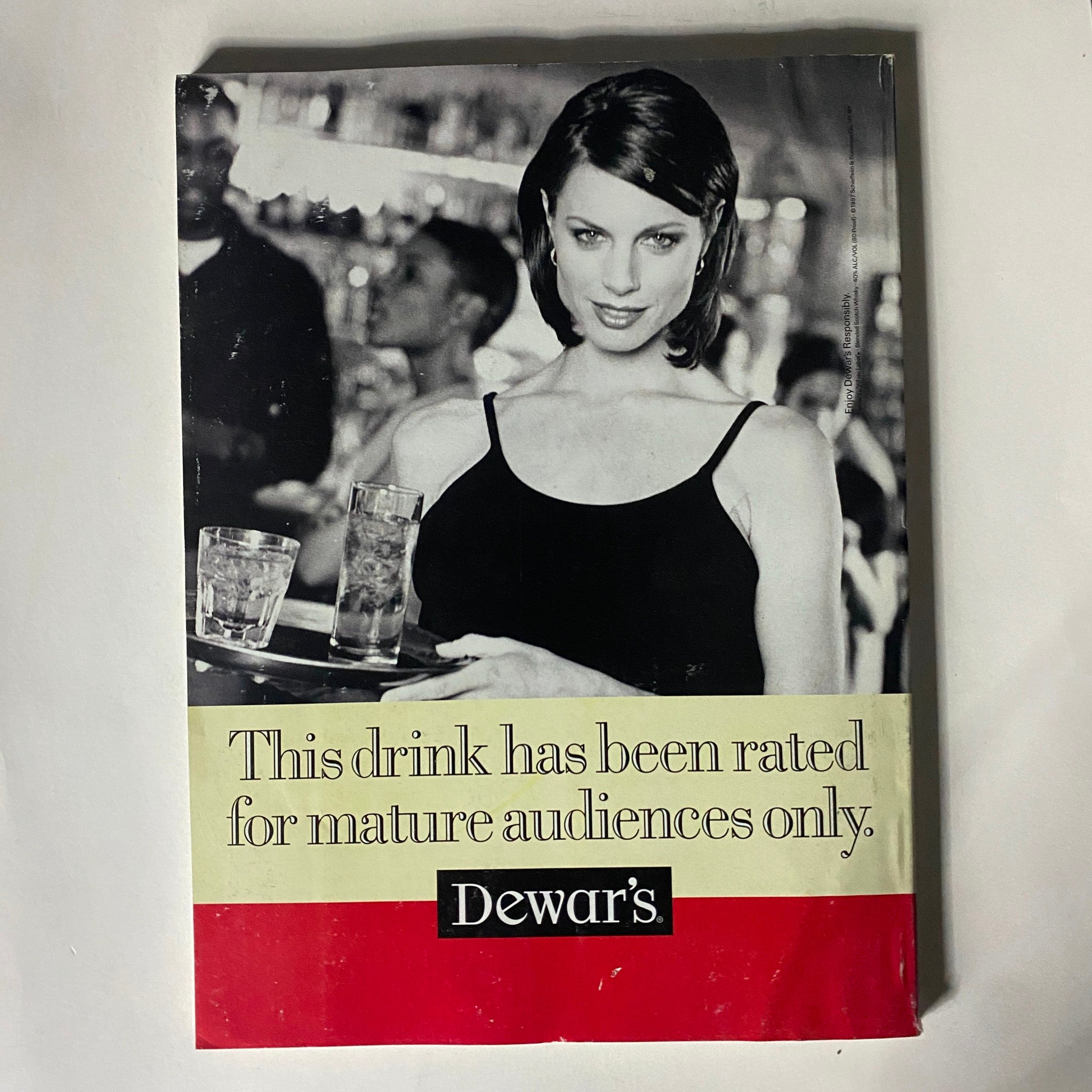 Back cover of Fortune Magazine October 13, 1997 showing an advertisement for Dewar's featuring a woman serving drinks, emphasizing adult beverage options with a vintage aesthetic.