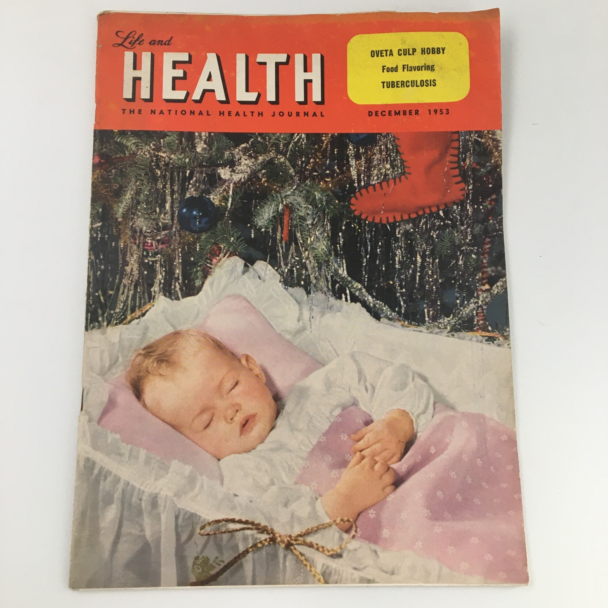 Cover of the VTG Life and Health Journal from December 1953 featuring Oveta Culp Hobby, emphasizing topics such as food flavoring and tuberculosis, with a seasonal theme including a sleeping child, Christmas decorations, and vibrant colors.