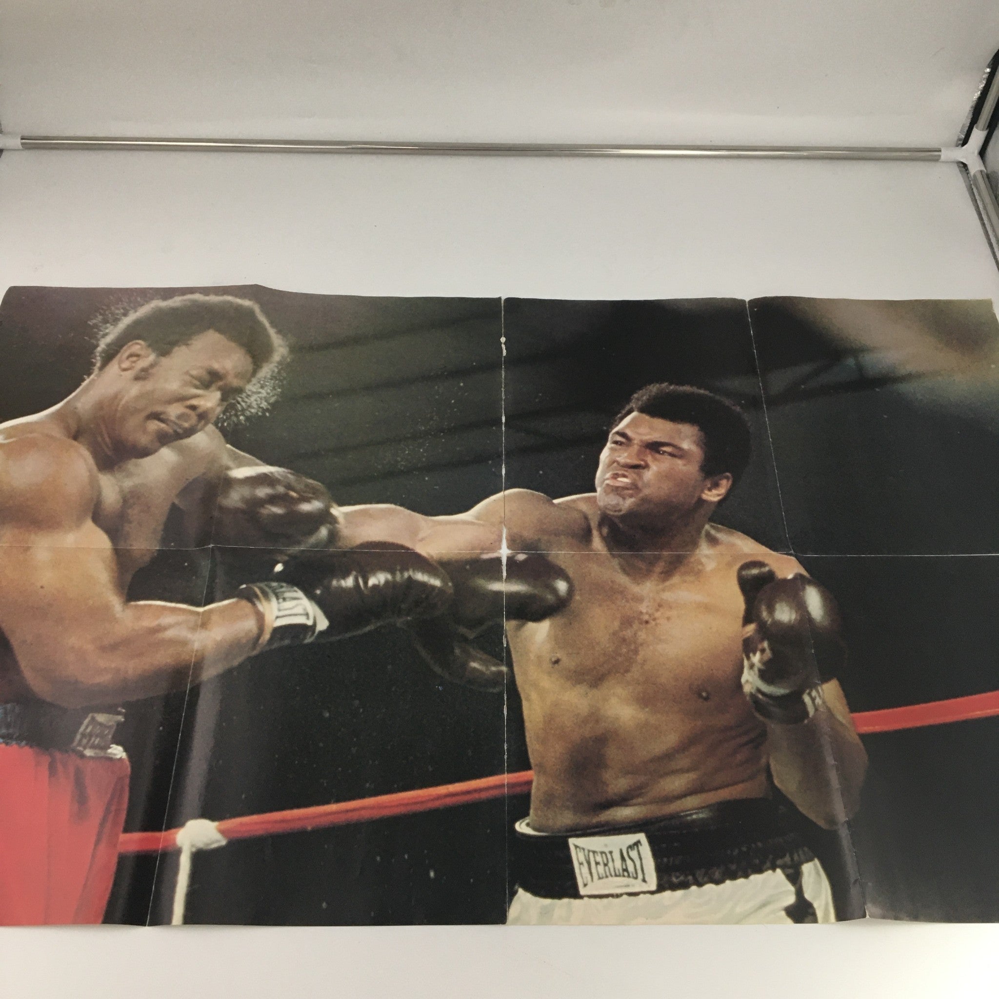 Inside view of the VTG 1975 Muhammad Ali Giant Poster Magazine showcasing an intense boxing scene with Muhammad Ali delivering a punch, capturing the dynamic action of the sport.