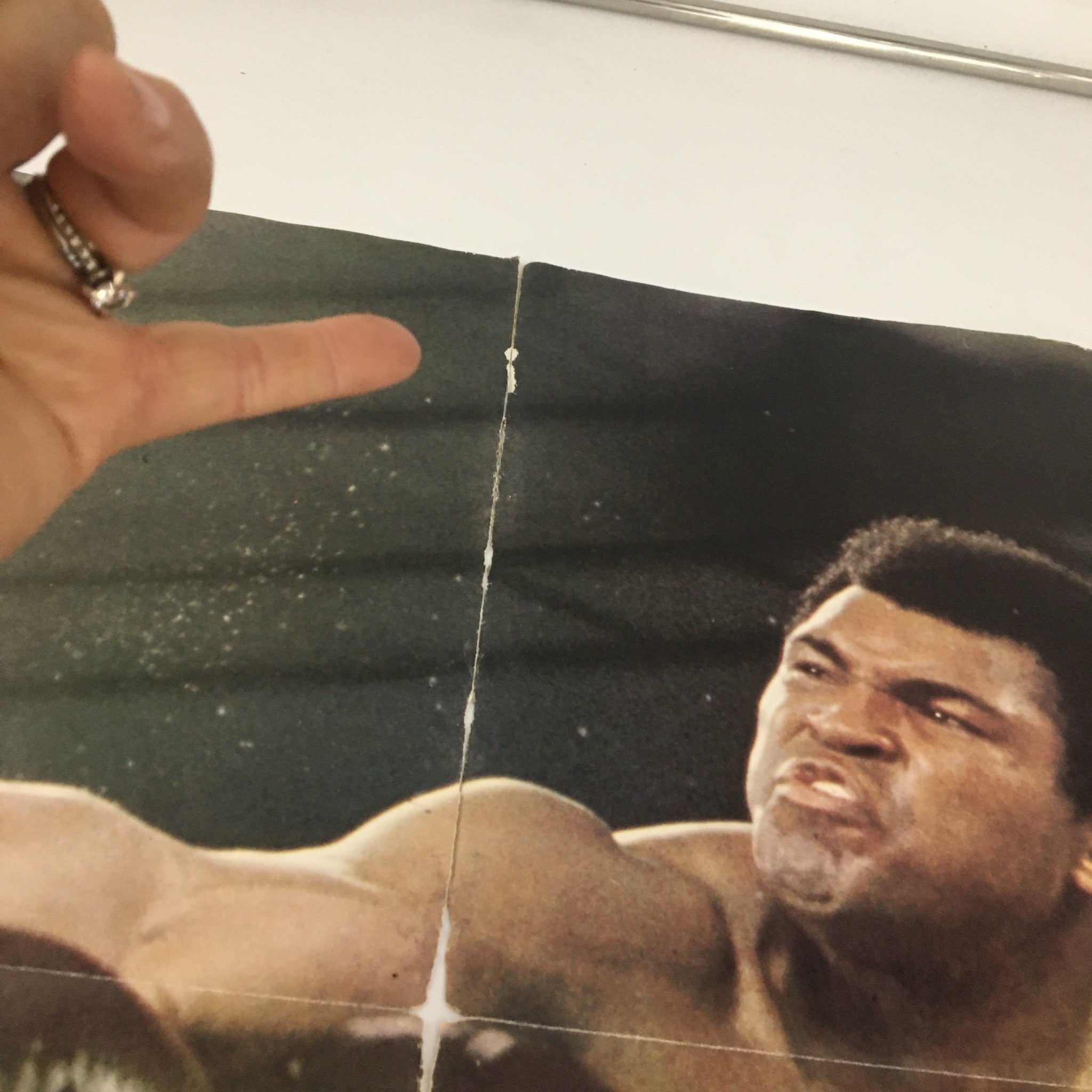Close-up detail of the 1975 Muhammad Ali Giant Poster Magazine showing a vintage image of Muhammad Ali, with visible wear indicating its age, part of a collectible newsstand edition.