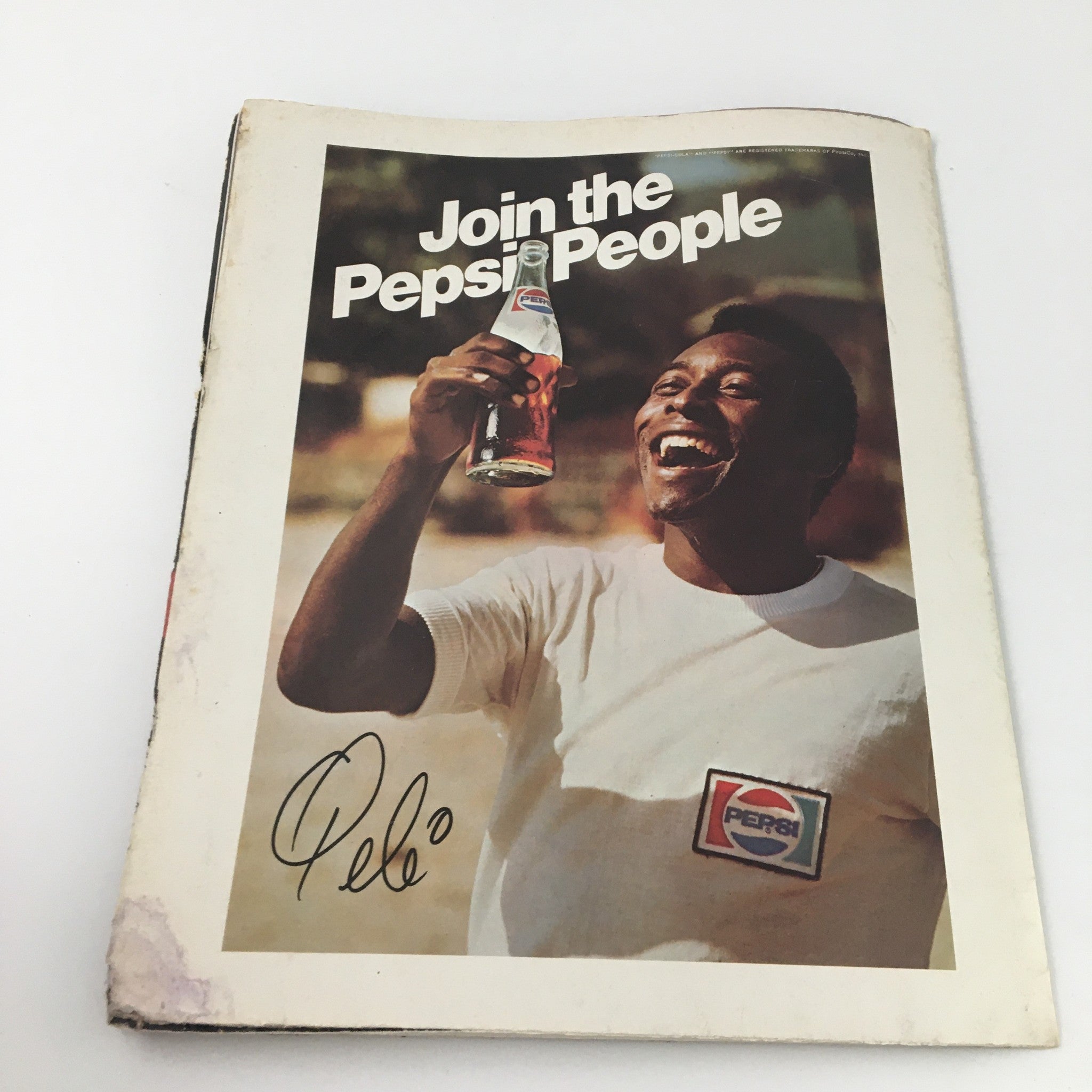 Front cover of a vintage magazine featuring a smiling Pele holding a Pepsi drink, along with the slogan 'Join the Pepsi People', showcasing a nostalgic moment in sports advertising.