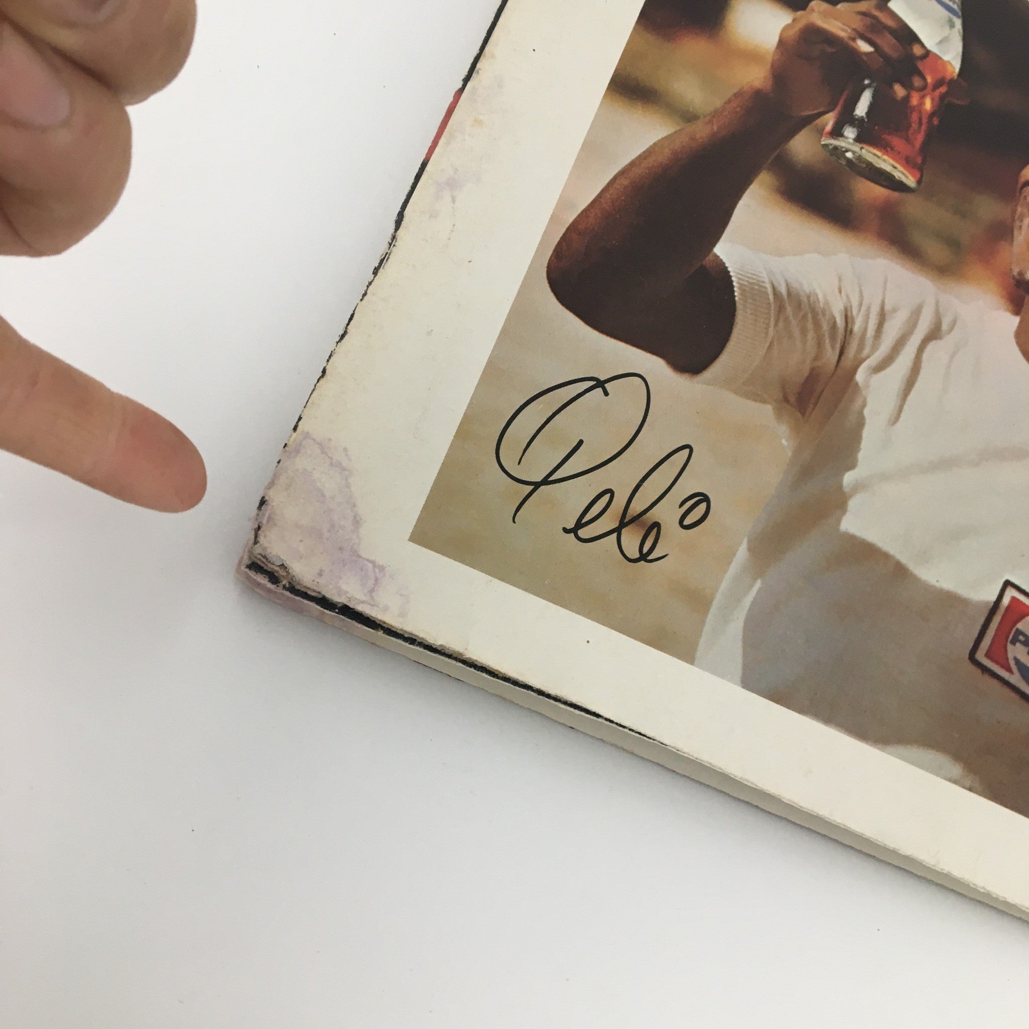 Side view of the vintage magazine featuring Pele, highlighting an autograph and showing the magazine's wear, indicative of its collectible nature in sports history.