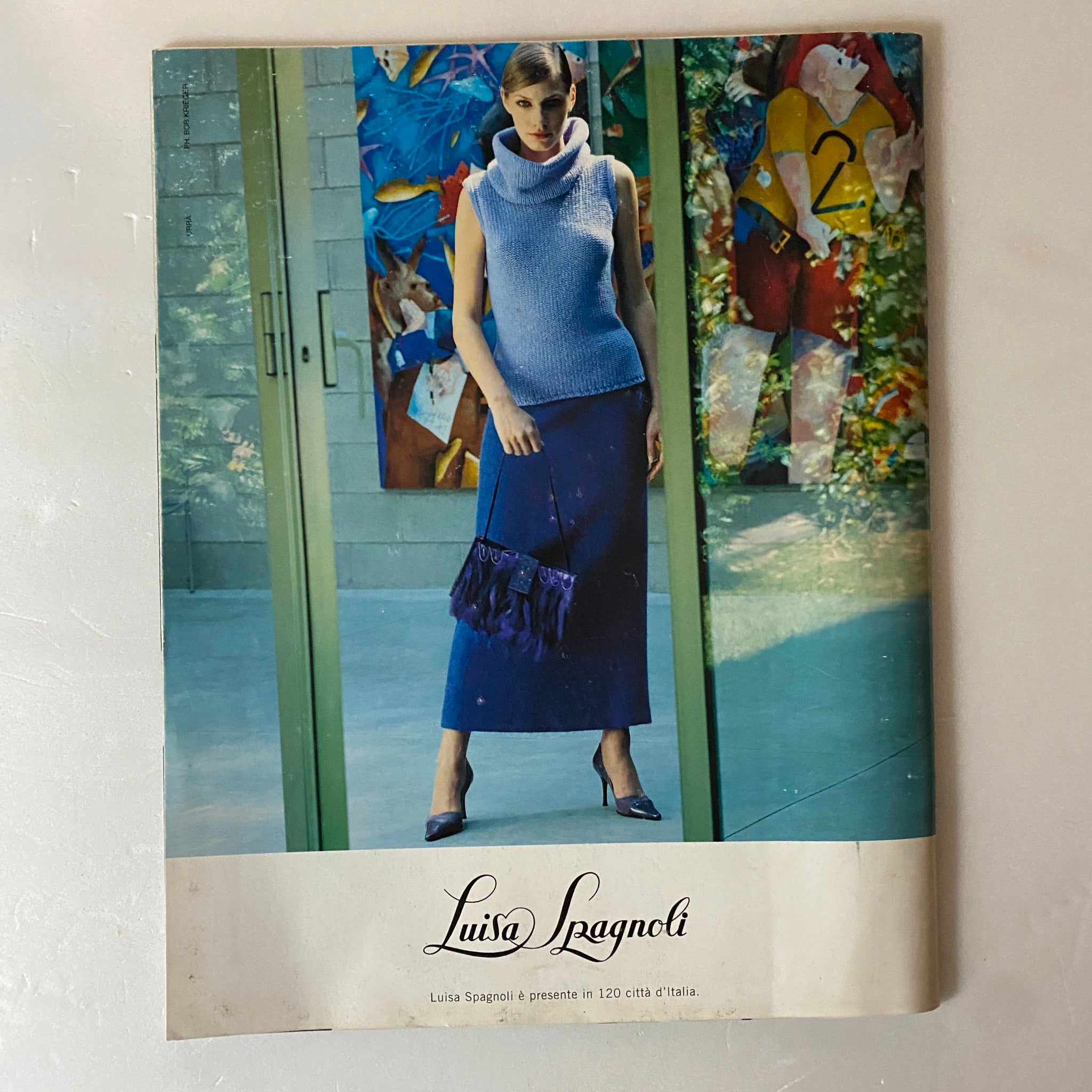 Vintage advertisement from Marie Claire French Supplement August 2000 featuring a model in a stylish blue ensemble by Luisa Spagnoli, showcasing 1970s Italian fashion.