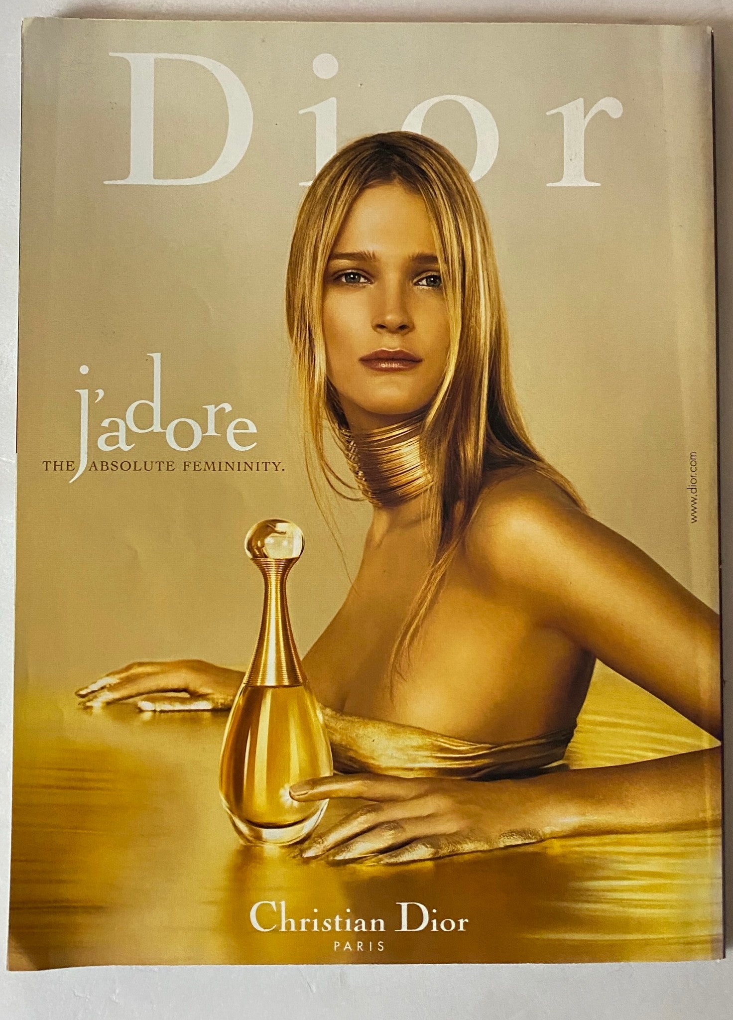 Dior advertisement featuring a model embodying elegance and femininity, with a tagline emphasizing luxury and beauty.