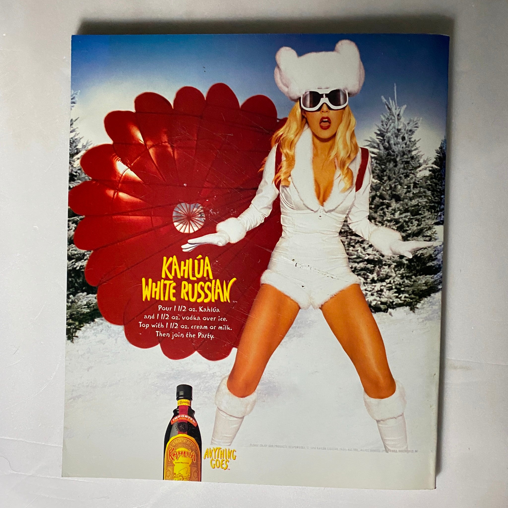 Advertisement for Kahlúa White Russian featured in Nylon Magazine November - December 1999, showcasing a stylish model in a winter-themed setting.