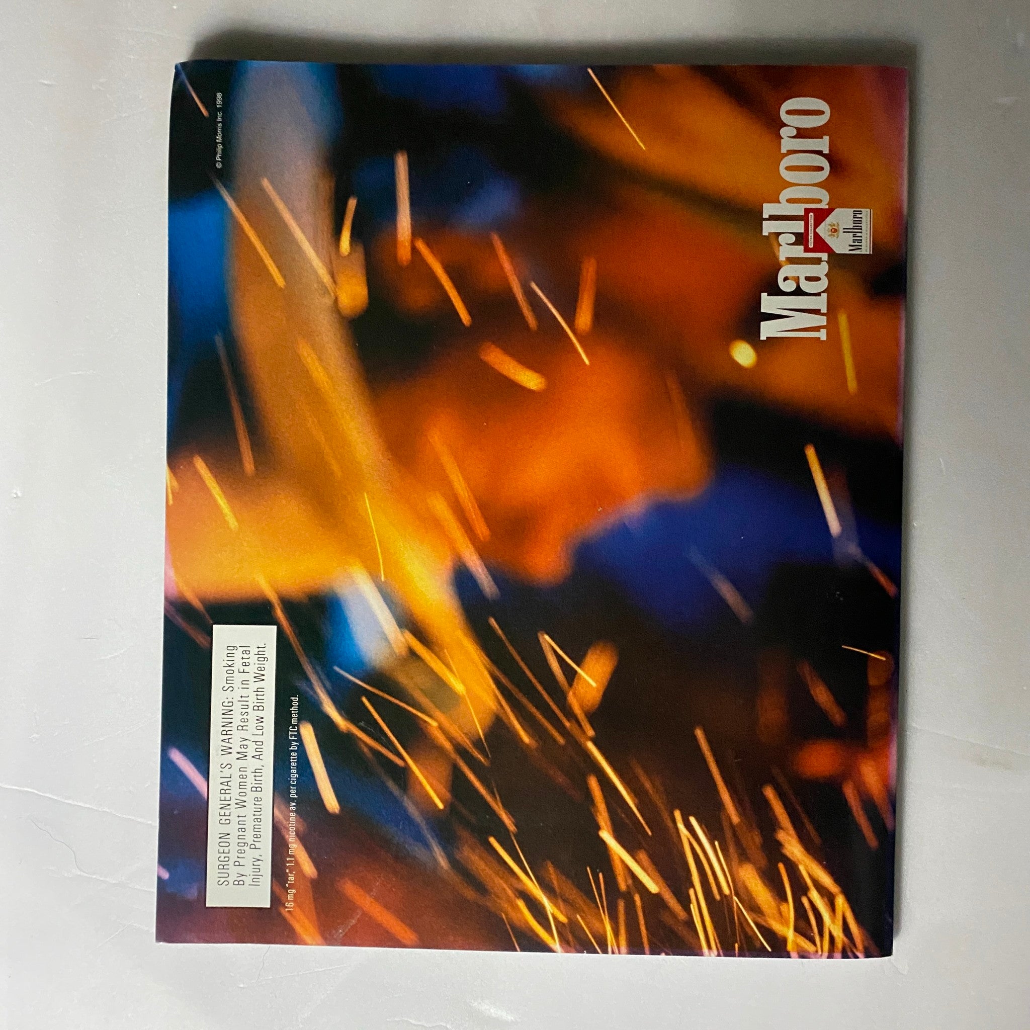 Advertisement page with a vibrant, abstract background from Detour Magazine August 1998, representing the visual aesthetics of the late 90s.