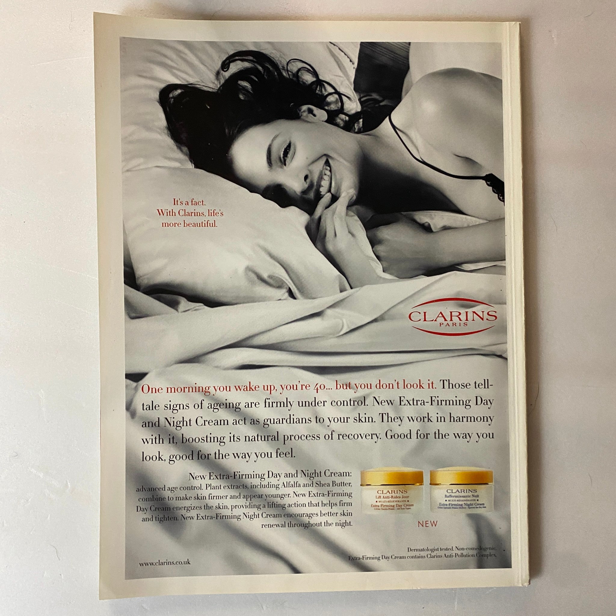Vintage advertisement from Harpers Magazine 2006 Spa Guide British Virgin Islands featuring Clarins skincare products, showcasing a model in a serene setting promoting skincare for age management.