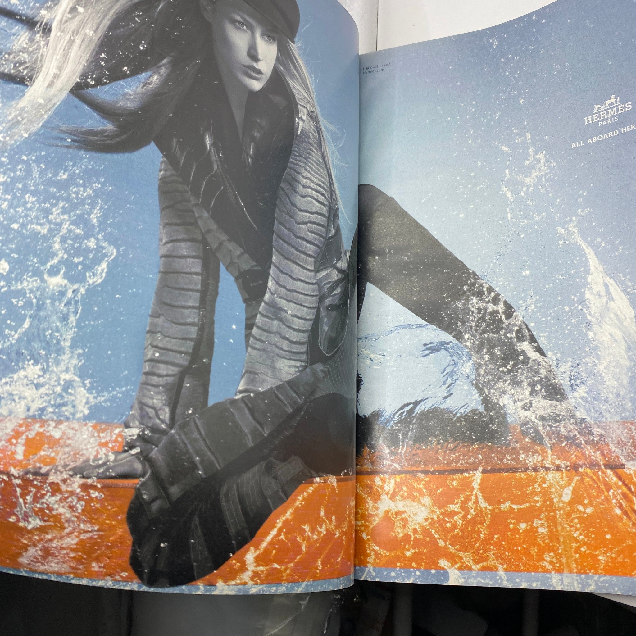 A fashion spread from The New York Times Style Magazine 2005 featuring an artistic model in motion against a backdrop of crashing waves, showcasing a dynamic and avant-garde style, linked to the iconic Tilda Swinton cover.