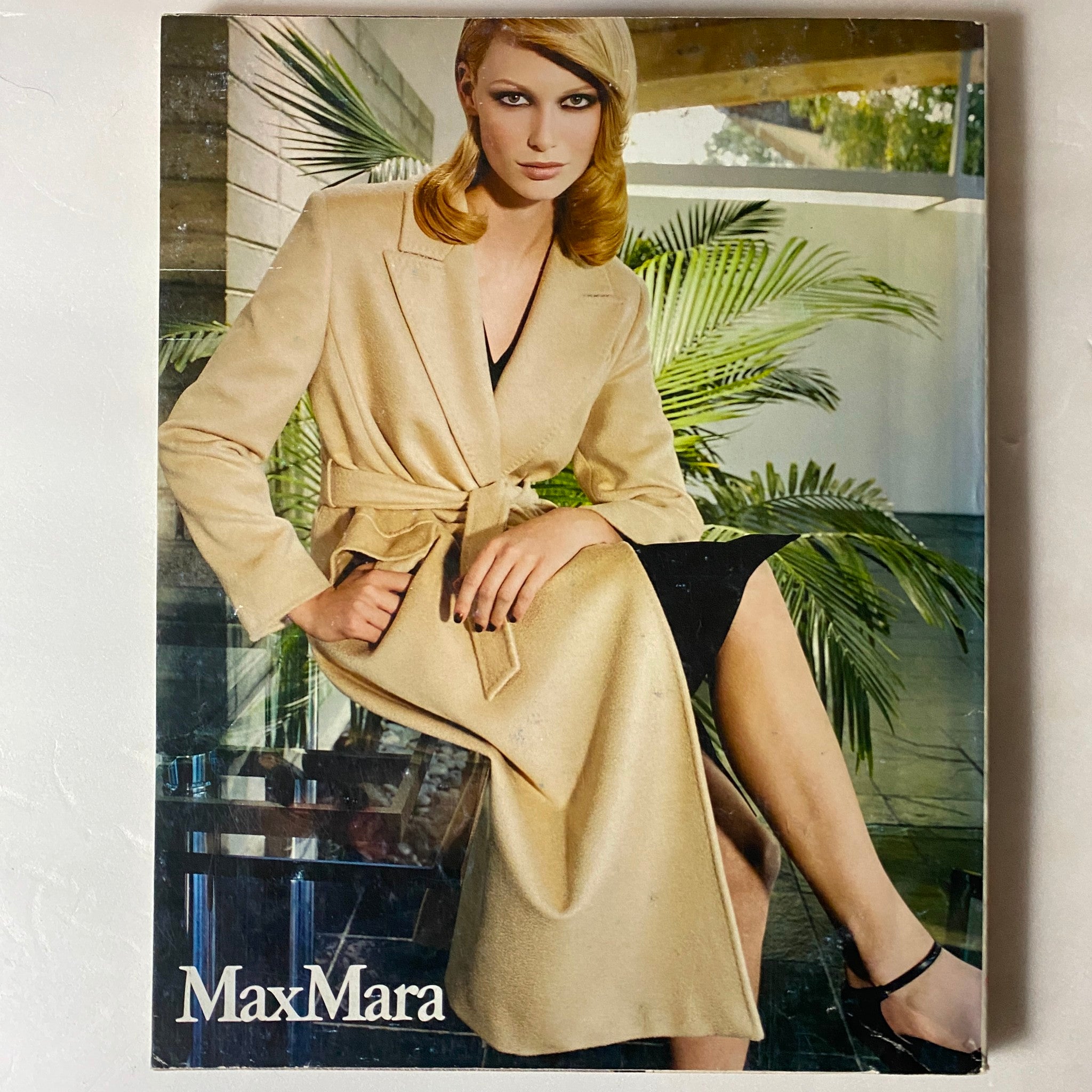 Fashion advertisement featuring a model in a beige MaxMara coat, highlighting classic luxury styles in the Marie Claire French Magazine August 2000.