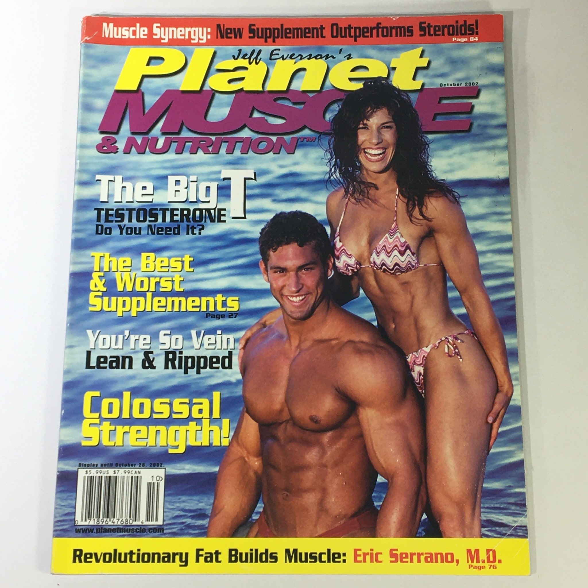Cover of Planet Muscle & Nutrition Magazine October 2002 featuring bodybuilders posing on the beach, highlights Dr. Eric Serrano, M.D., discussing topics like testosterone and supplements, showcasing vintage fitness culture.