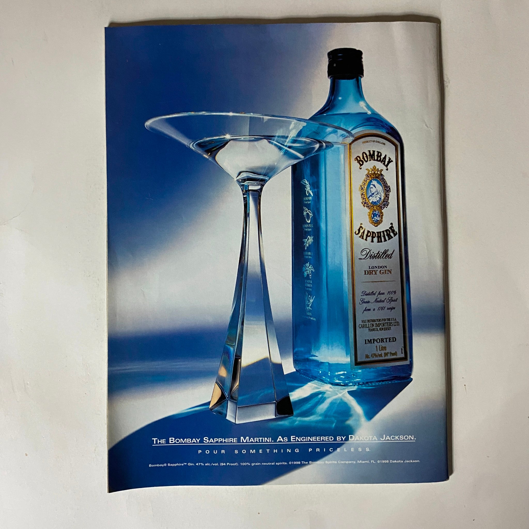 Ad for Bombay Sapphire gin with a blue palette and a martini glass, emphasizing elegance and sophistication.