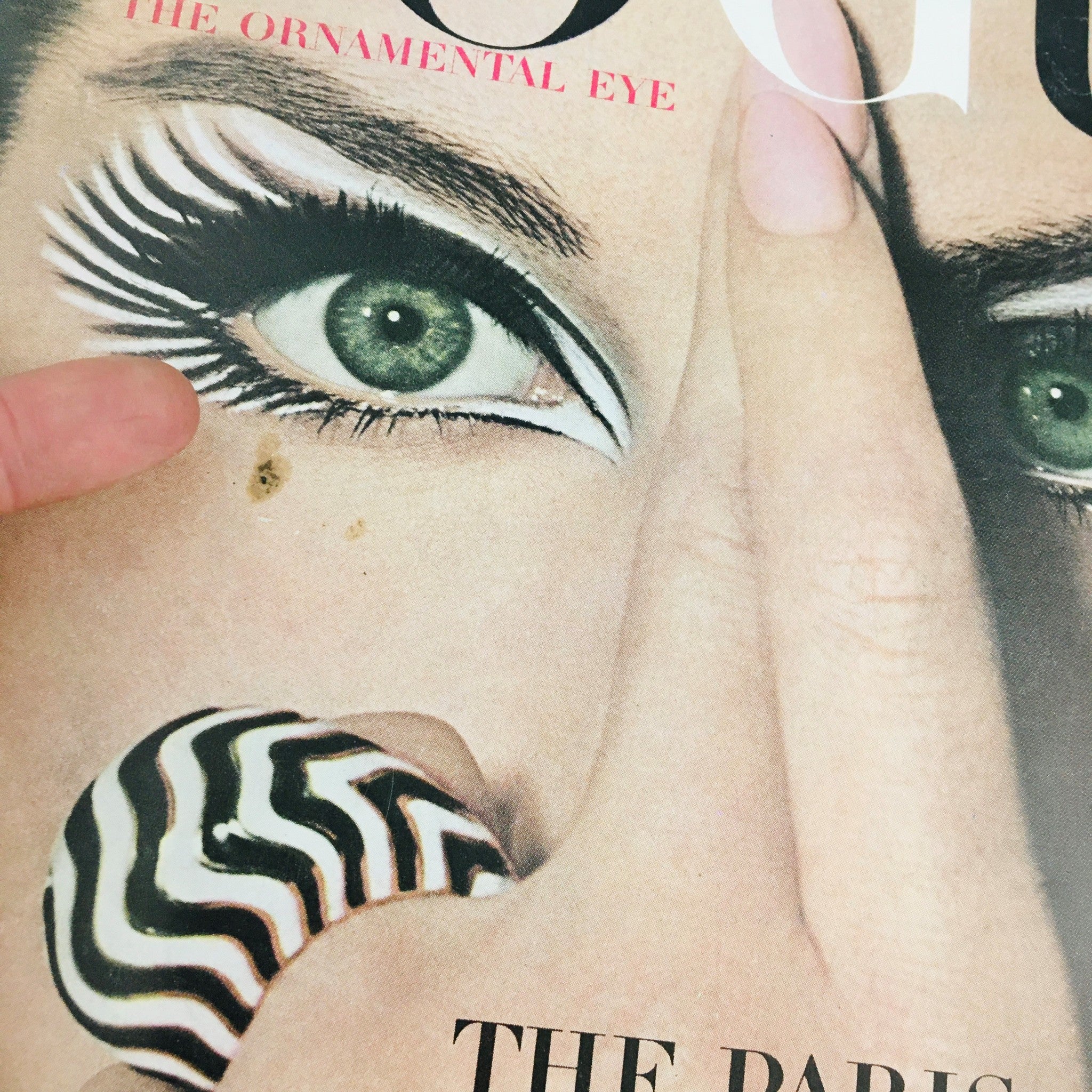 Cover of Vogue Magazine September 15 1964 featuring a striking eye makeup design with a finger and a black and white patterned accessory, illustrating the theme 'The Paris Fascination' and showcasing French fashion of the era.