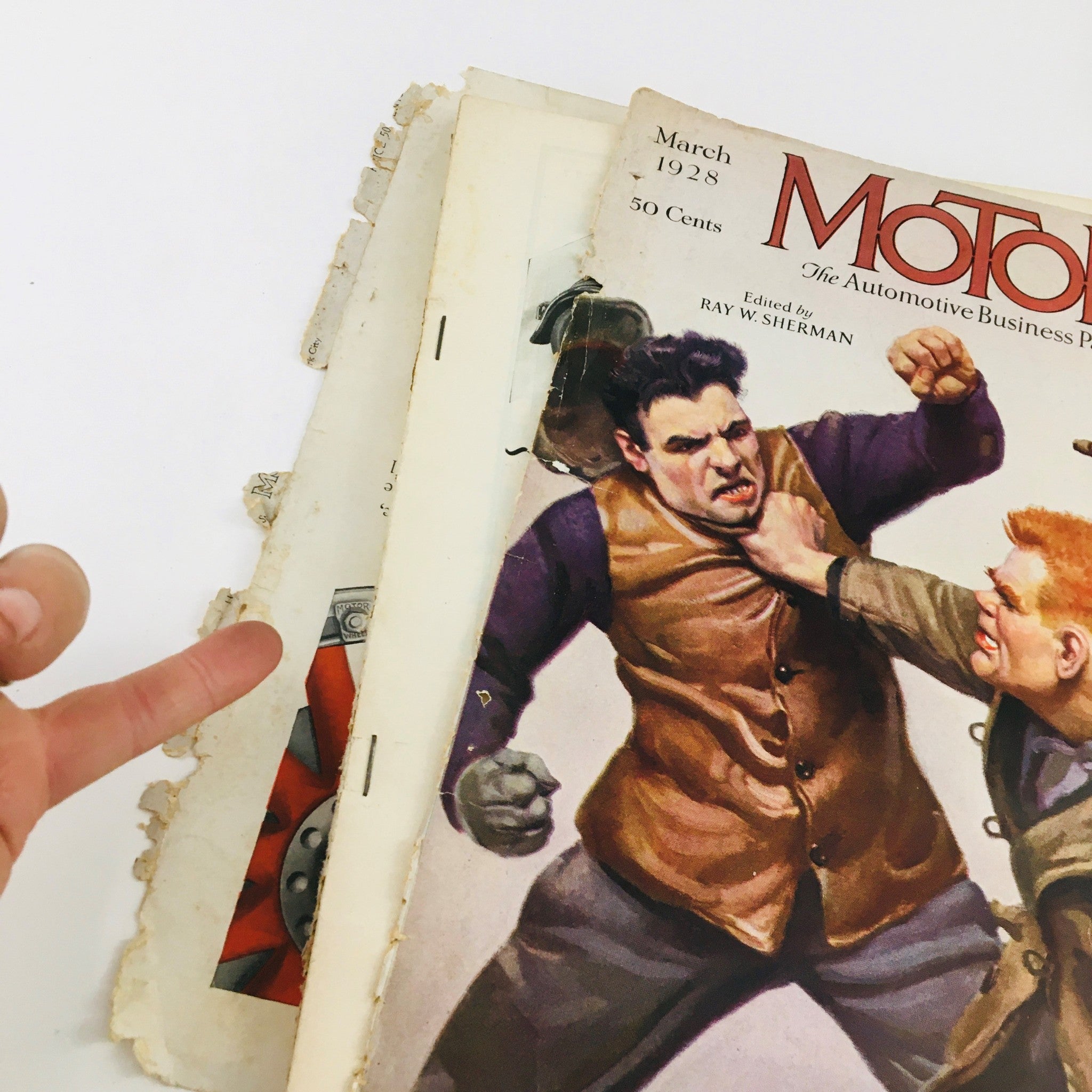 Inside view of VTG Motor Magazine March 1928, highlighting the magazine's vintage wear and illustration style focusing on trucking and automotive industry themes.