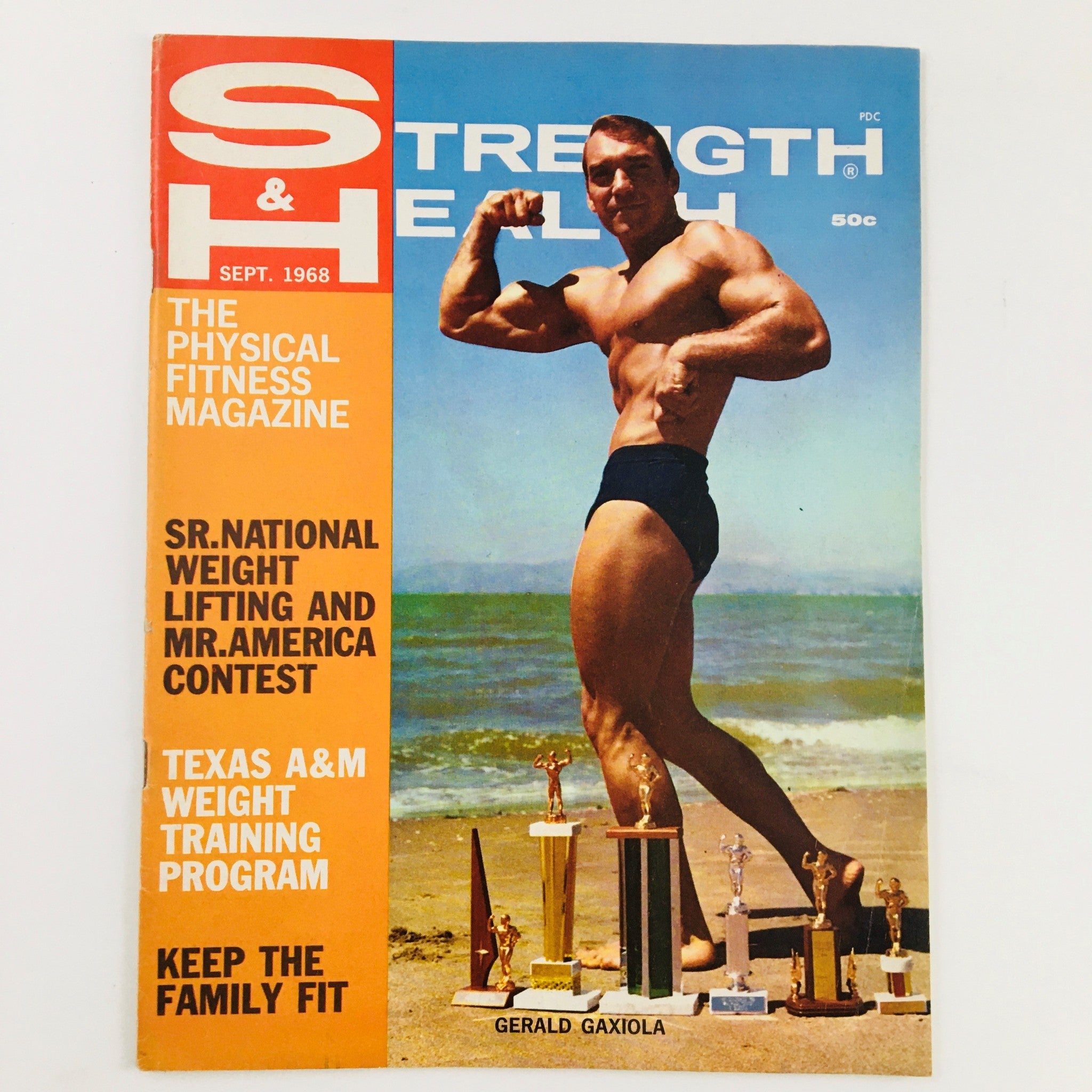 Cover of Strength & Health Magazine September 1968 featuring bodybuilder Gerald Gaxiola showcasing his physique, with trophies on the beach.