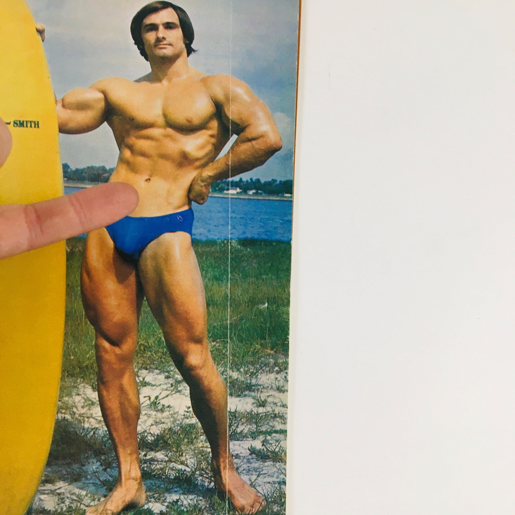Muscular Development Magazine July 1975 featuring bodybuilder Rich Baldwin posing outdoors near a surfboard, showcasing the bodybuilder's physique.
