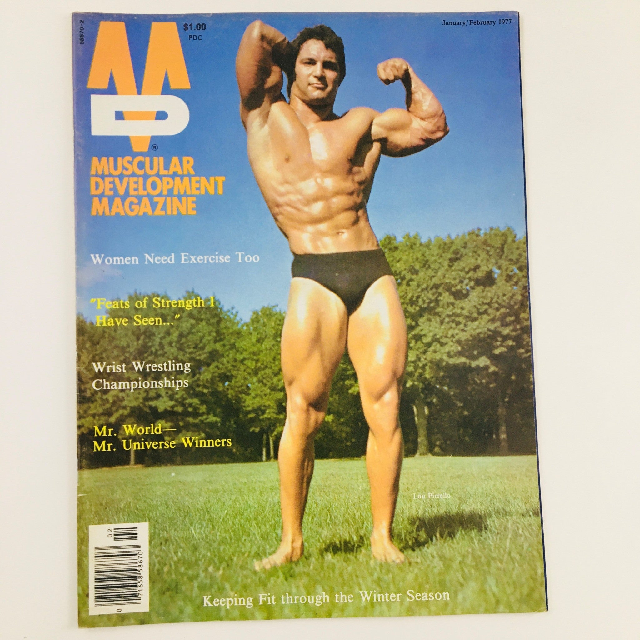 Cover of Muscular Development Magazine January 1977 featuring Lou Pirrello, Mr. Universe, showcasing his impressive physique against a natural backdrop.
