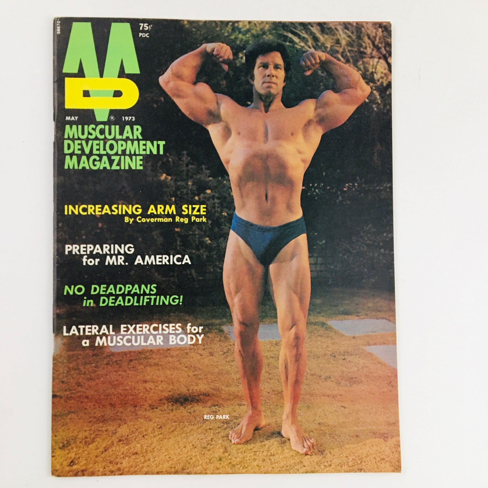 Cover of Muscular Development Magazine May 1973 featuring Reg Park showcasing bodybuilding physique and articles on increasing arm size and preparing for Mr. America.
