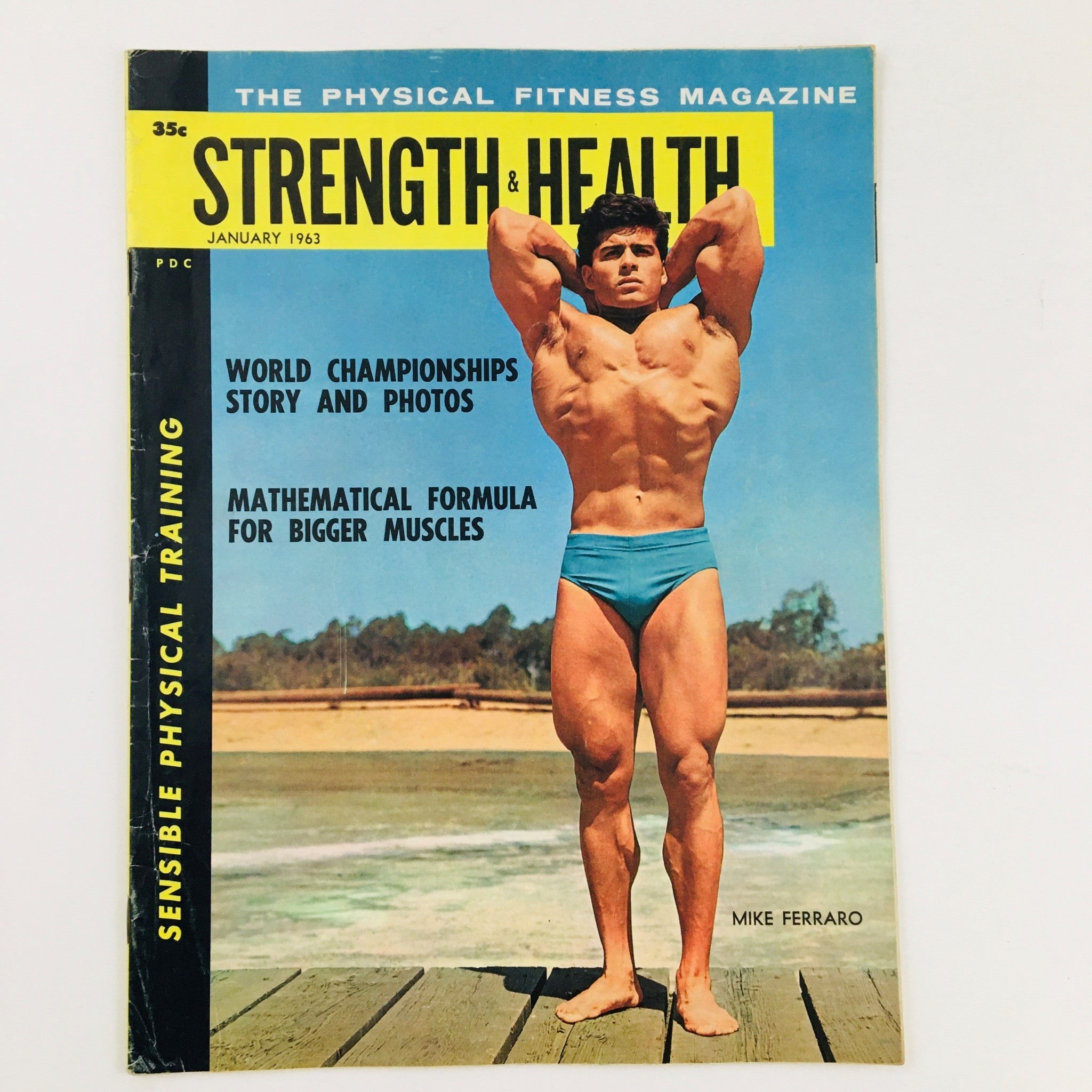 Strength & Health Magazine January 1963 cover featuring bodybuilder Mike Ferraro posing by the beach, highlighting the themes of strength training and fitness culture.
