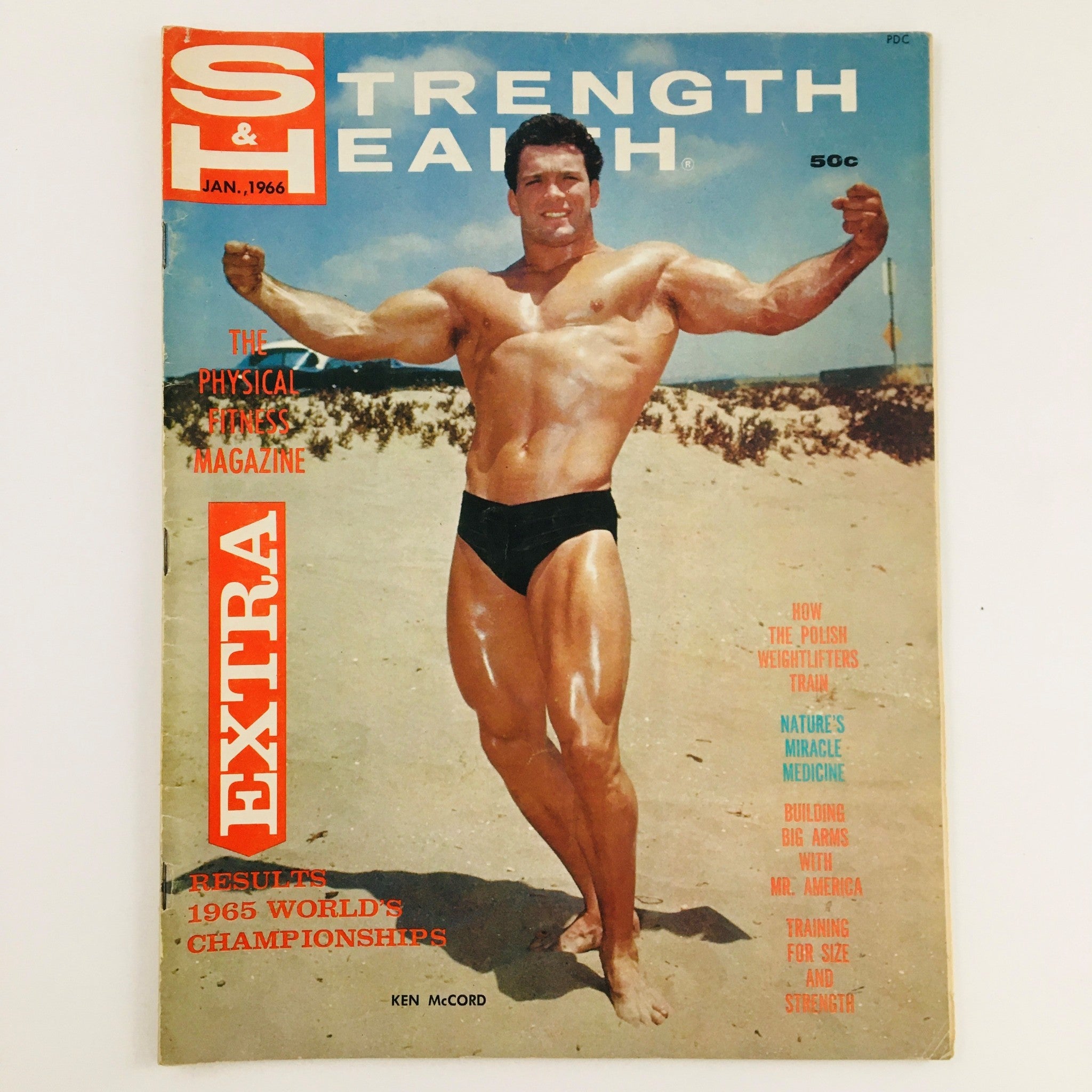 Cover of Strength & Health Magazine January 1966 featuring bodybuilder Ken McCord in a vintage beach setting, showcasing fitness culture of the 1960s.