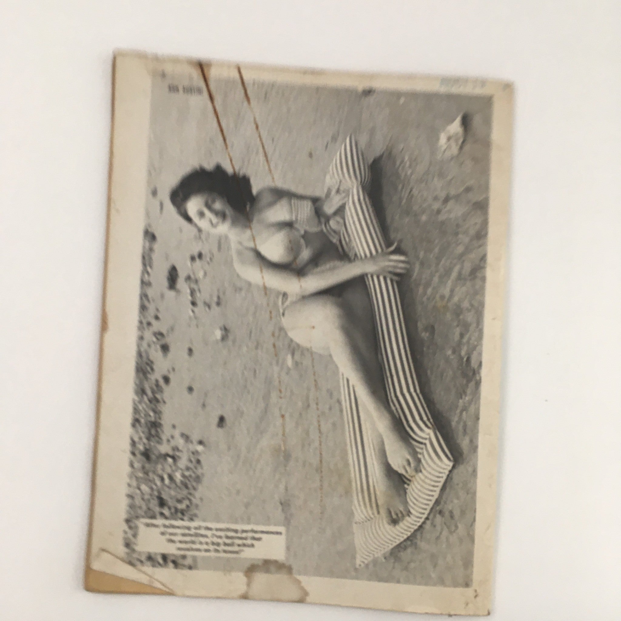 A pin-up style photo from Popular Cartoons January 1968, depicting a model lounging by the beach, showcasing vintage aesthetics of the era.