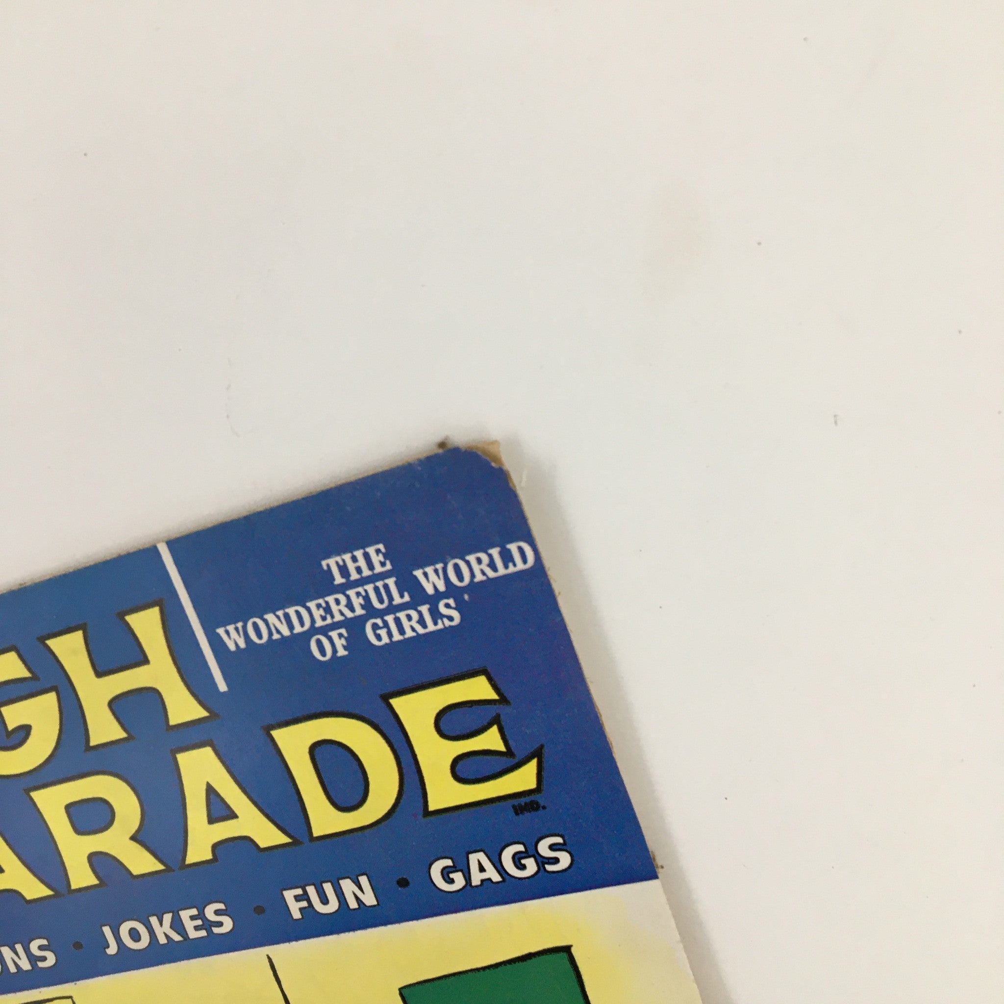 Upper corner of the Laugh Parade Humor Magazine July 1962 cover, showcasing the title and tagline The Wonderful World of Girls.