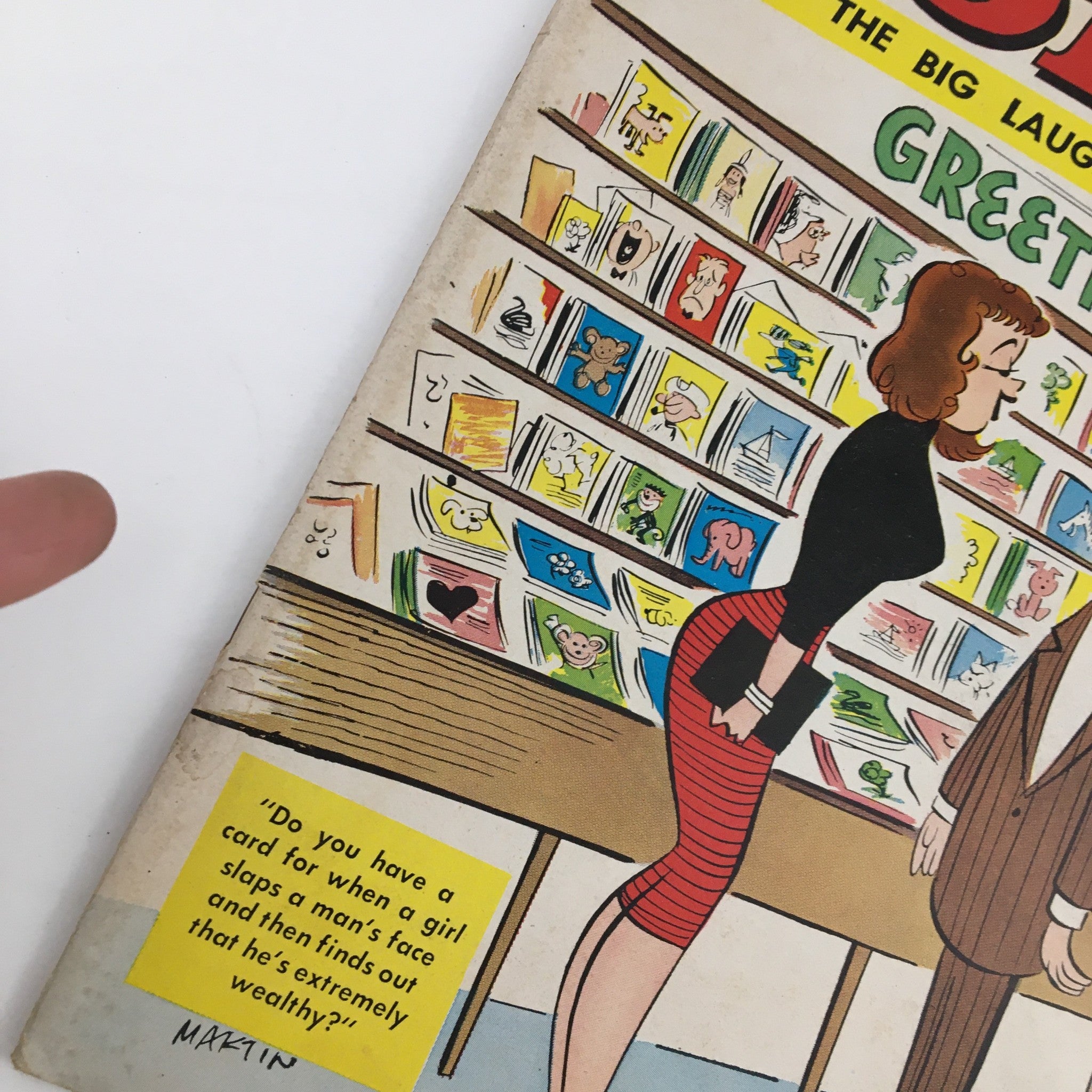 Close-up of Popular Jokes Laugh Magazine cover from May 1963 depicting a comic illustration of a woman discussing greeting cards with a man, highlighting unique humor.