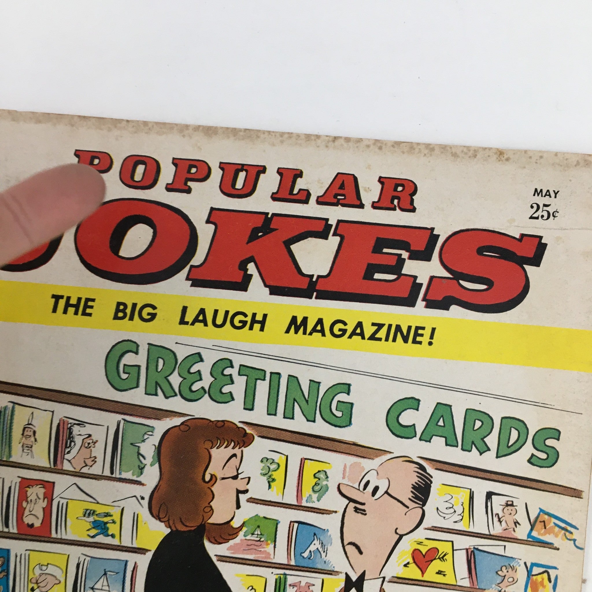Detailed view of the title Popular Jokes Laugh Magazine May 1963, emphasizing its vintage design and comical theme on greeting cards.