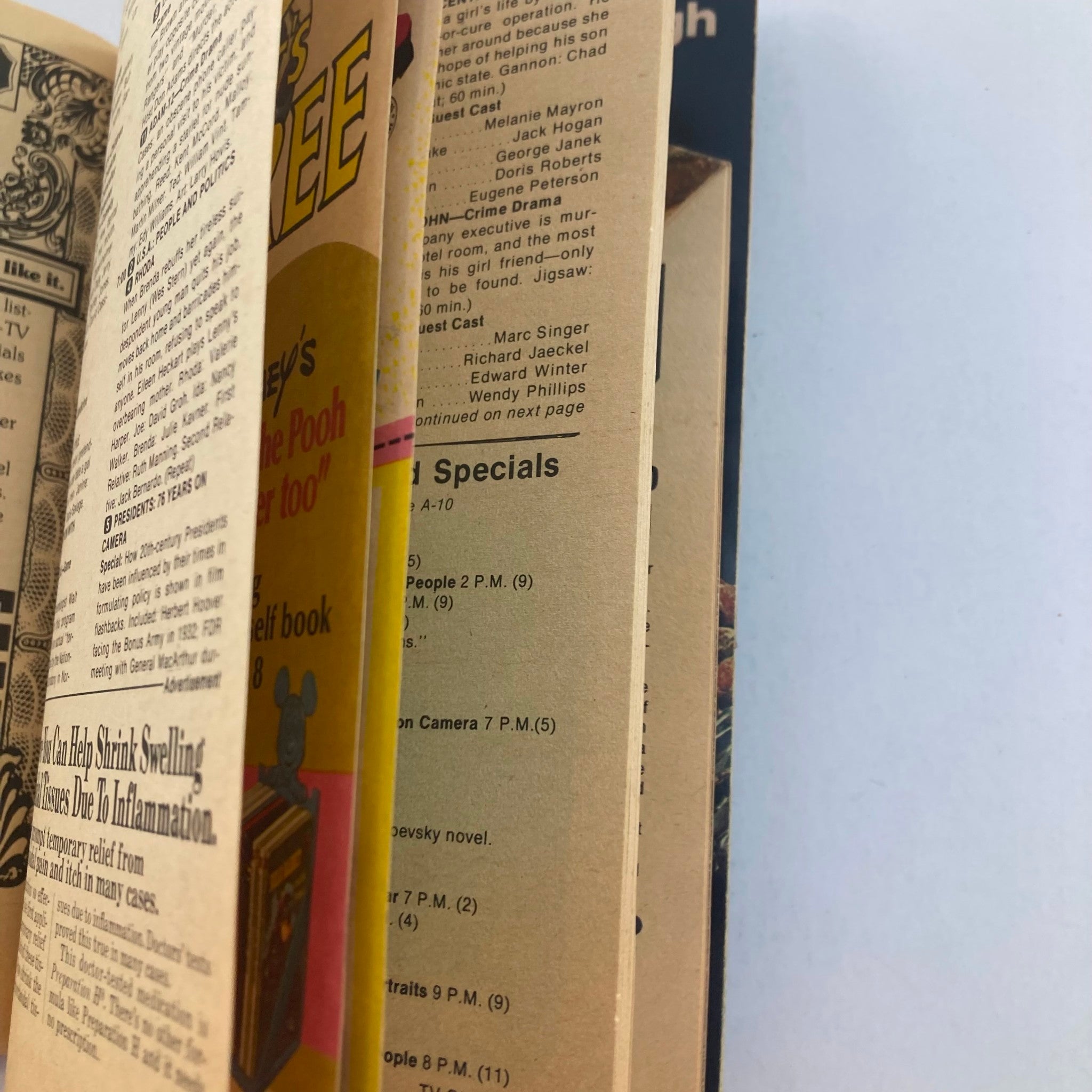 Close-up of pages from TV Guide Magazine June 12 1976 #1211 displaying different program listings and advertisements, highlighting vintage content.