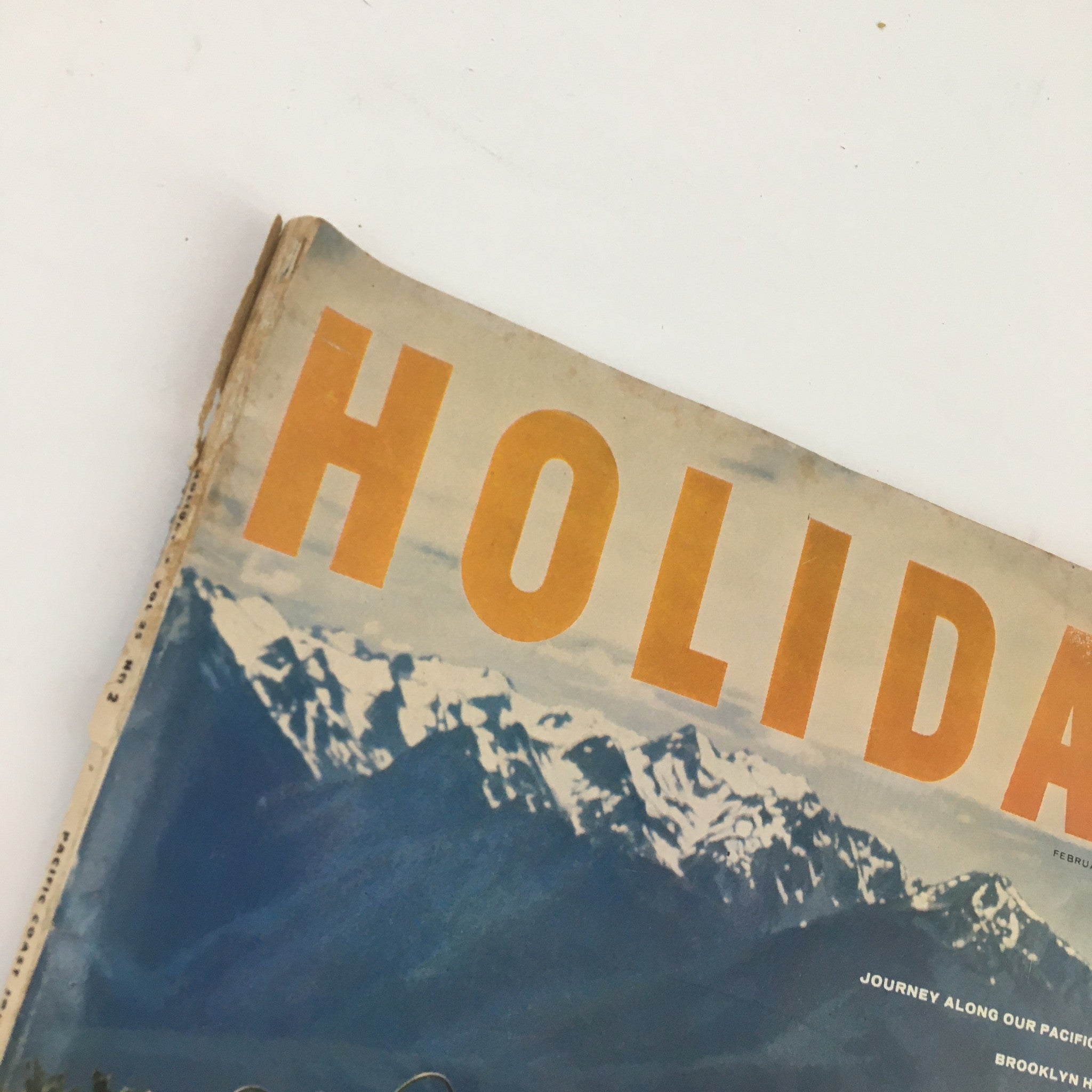 Close-up of the title on the cover of Holiday Magazine February 1959 showcasing the bold lettering and picturesque background.