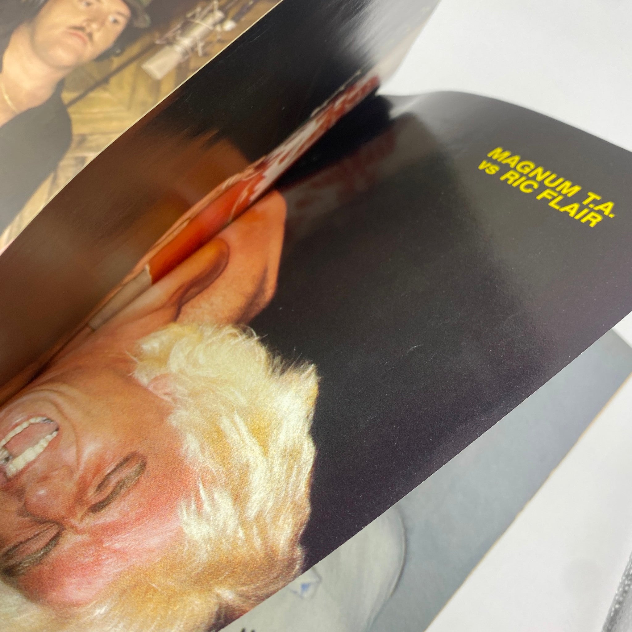 Inside spread of the VTG Superstar Wrestler July 1986 magazine showing a match highlight of Magnum T.A. vs Ric Flair with vibrant photography.